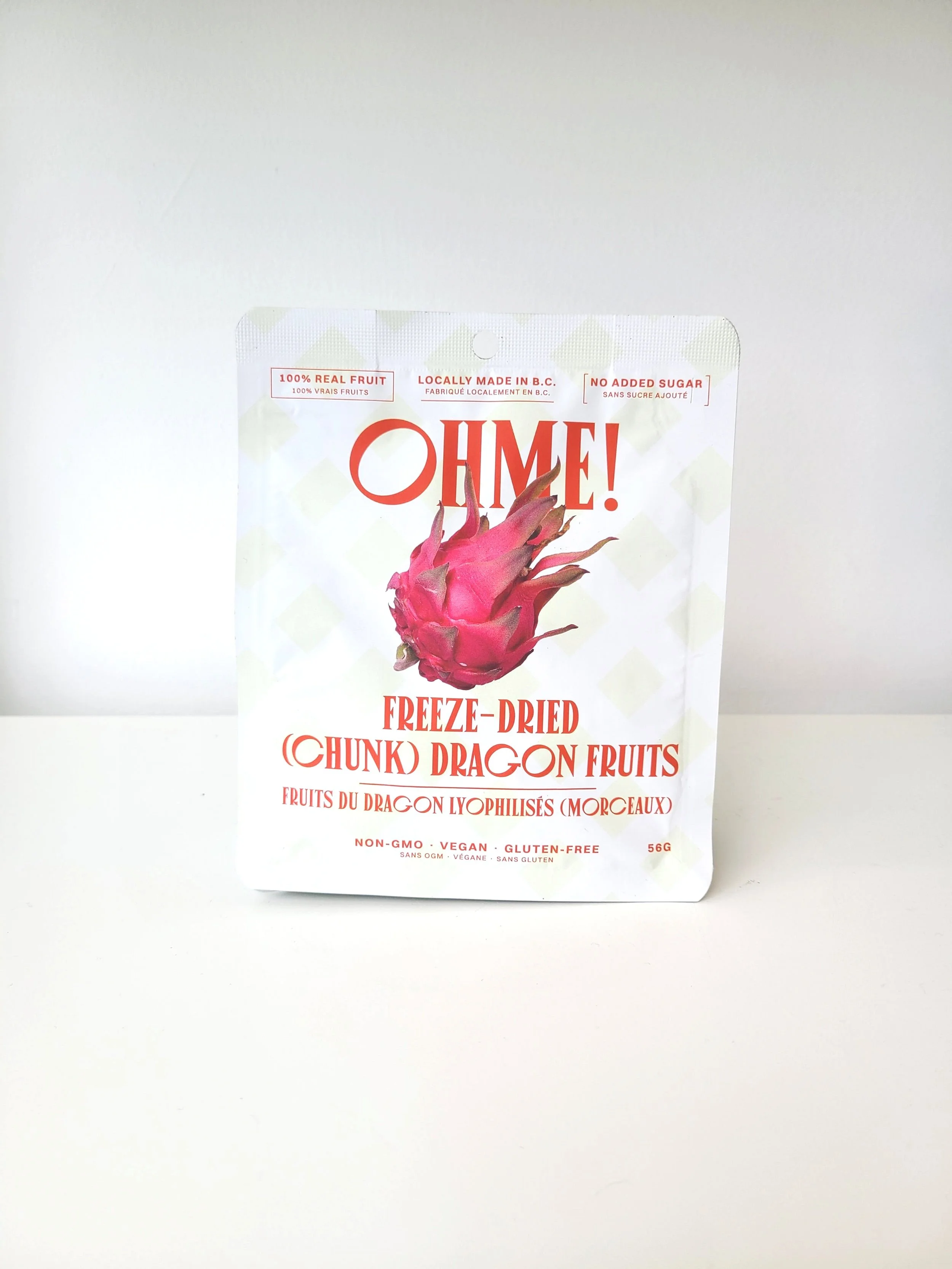 Package of freeze-dried dragon fruit chips with red and pink fruit on white background.