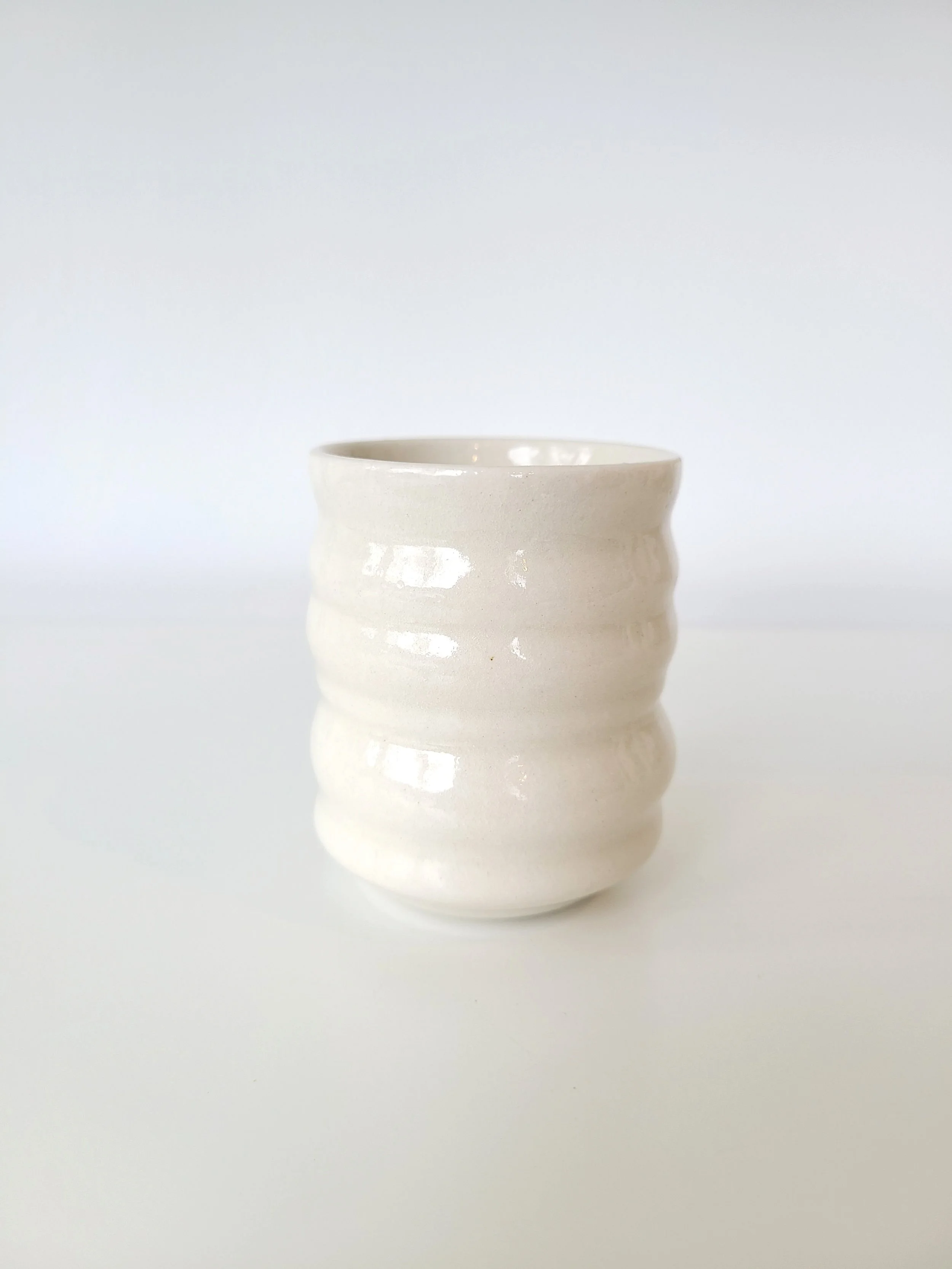 White ceramic cup on a white background.