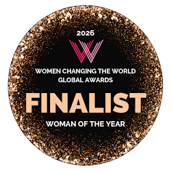 Circular award badge with a black background and gold glitter border, featuring pink and white text that reads '2026 Women Changing the World Global Awards Finalist Woman of the Year'.