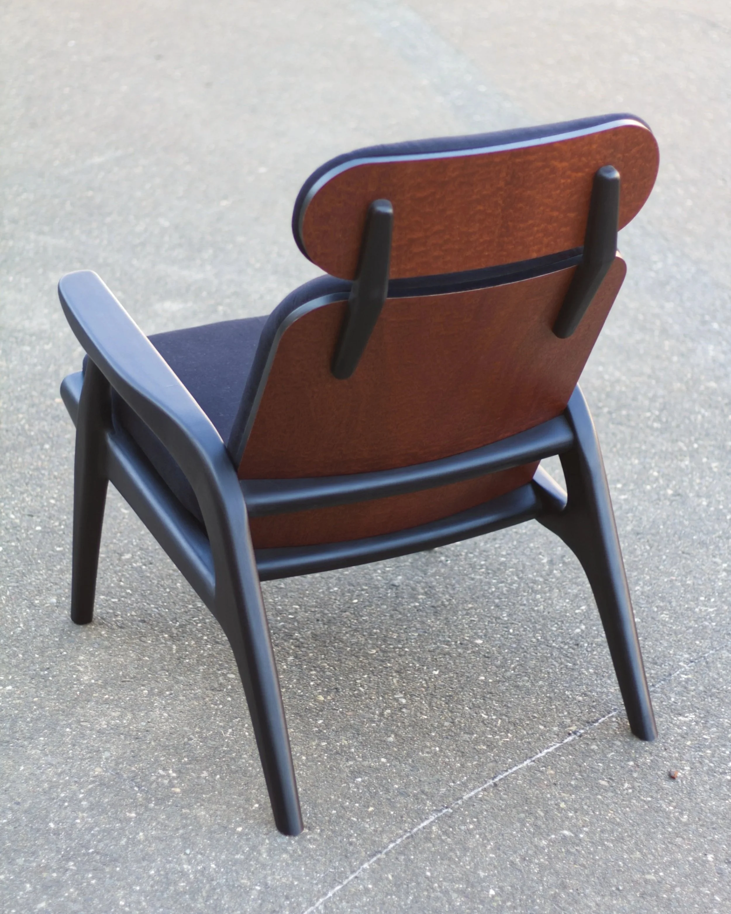 Empty brown and black office chair on a gray concrete ground.