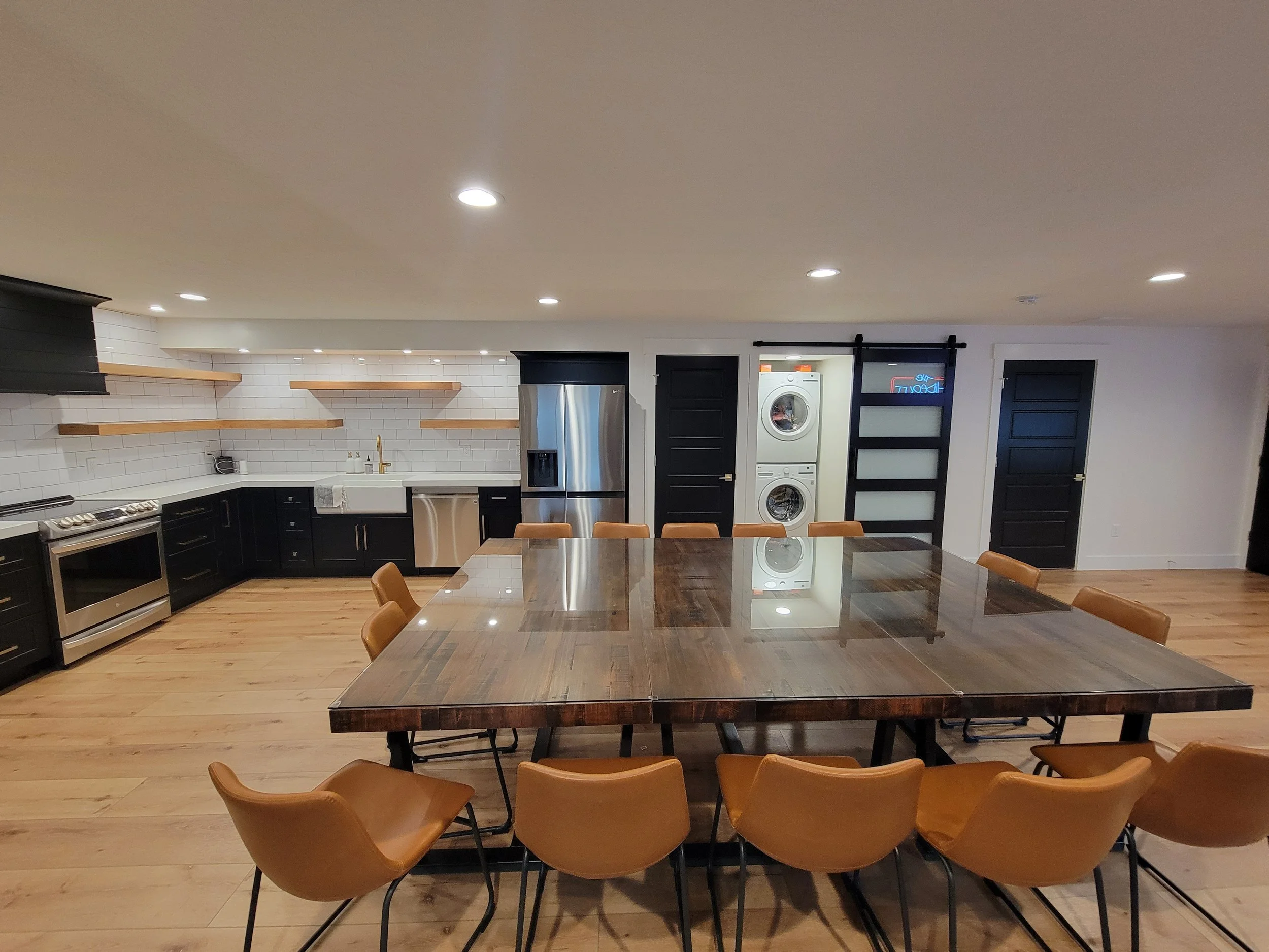 Modern basement kitchen remodel with subway tile backsplash, custom cabinetry, open shelving, and stainless steel appliances in Tooele Utah
