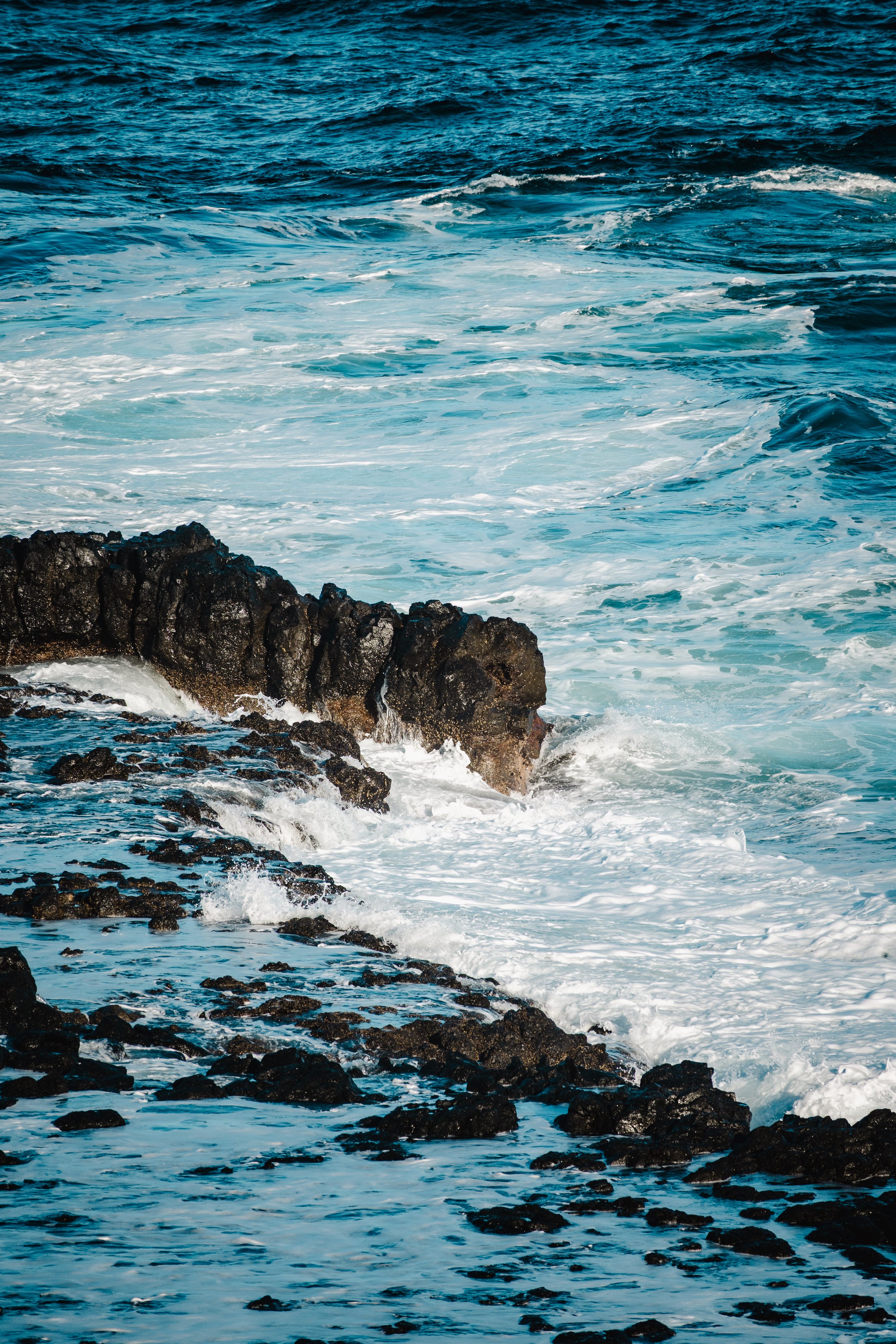 Ocean waves crashing against rocky shoreline.