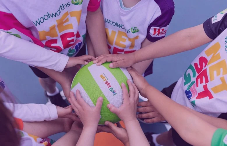 net set go participants with hands on a ball