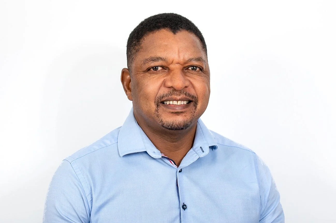 Cliff Faya, accountant at ATS Taxation Services Gold Coast, smiling in light blue business shirt.