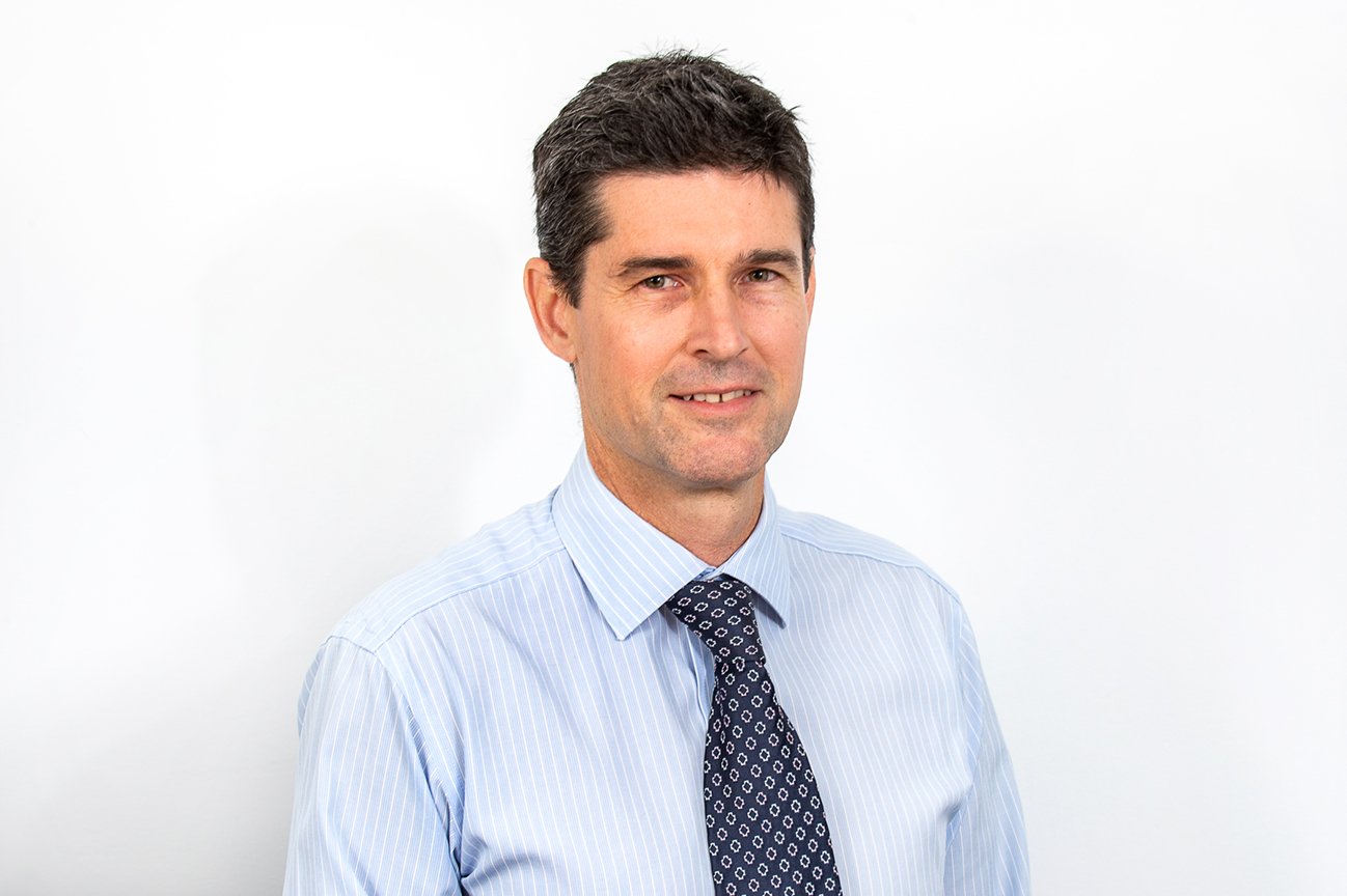 Andrew Evans, Director of Accounting at ATS Taxation Services, wearing blue striped shirt and tie.