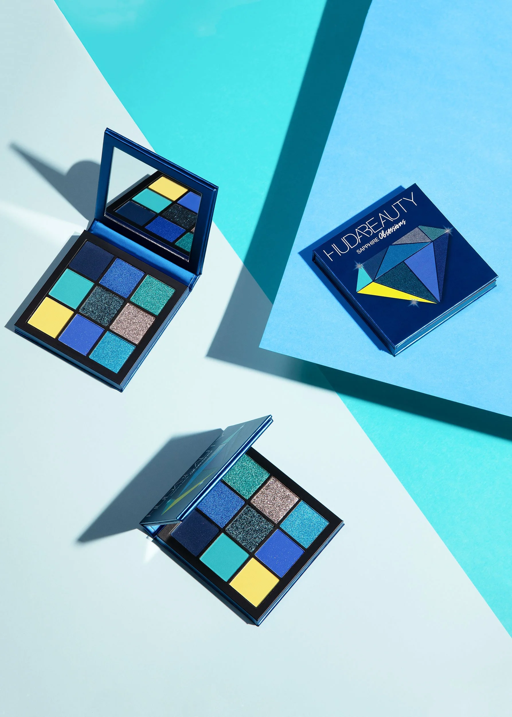 London Photographer & Retoucher, Lizzy Clough: Beauty photography of Huda Beauty blue eyeshadow palette, against a blue background