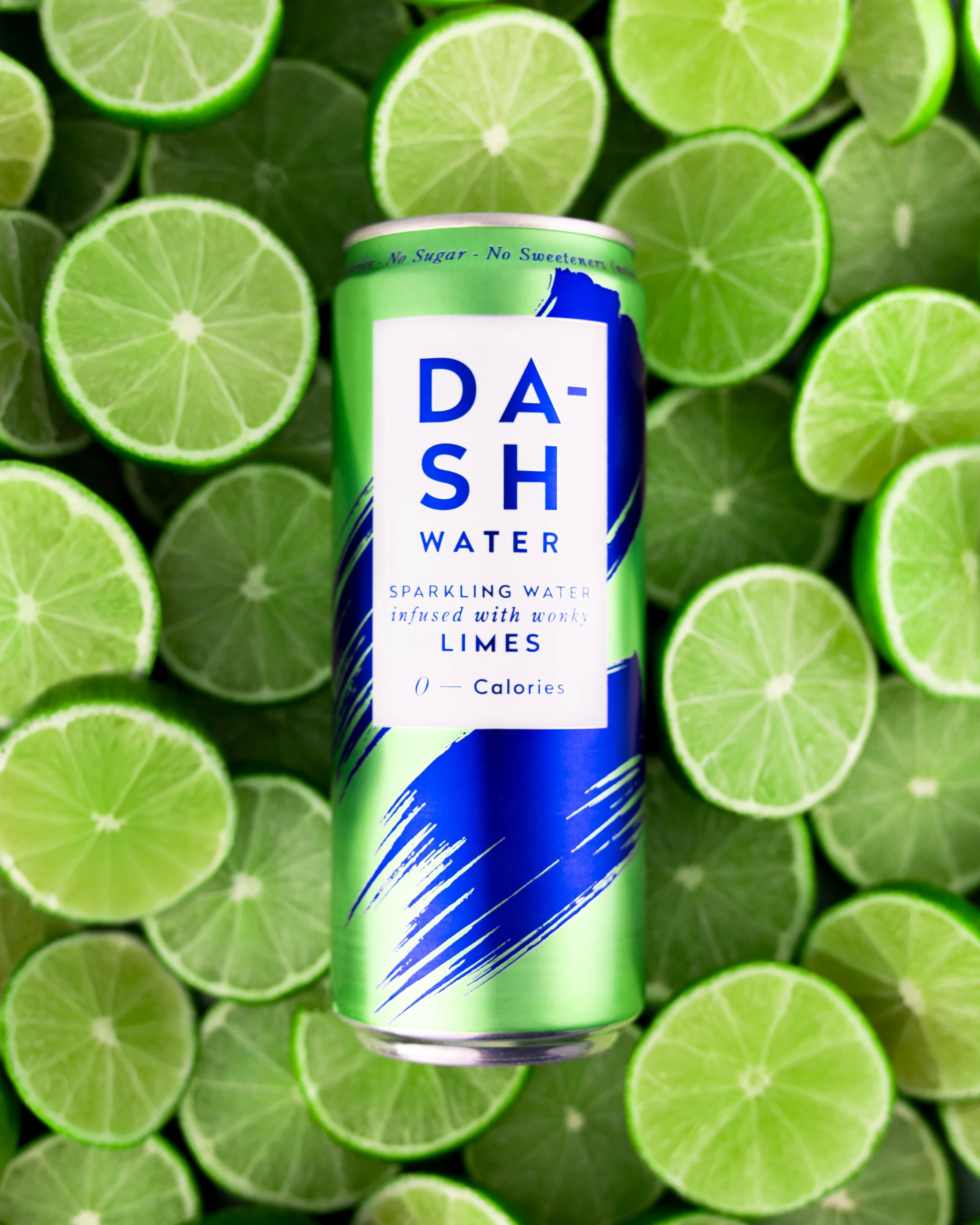 This image features Dash lime water surrounded by limes, ingredients