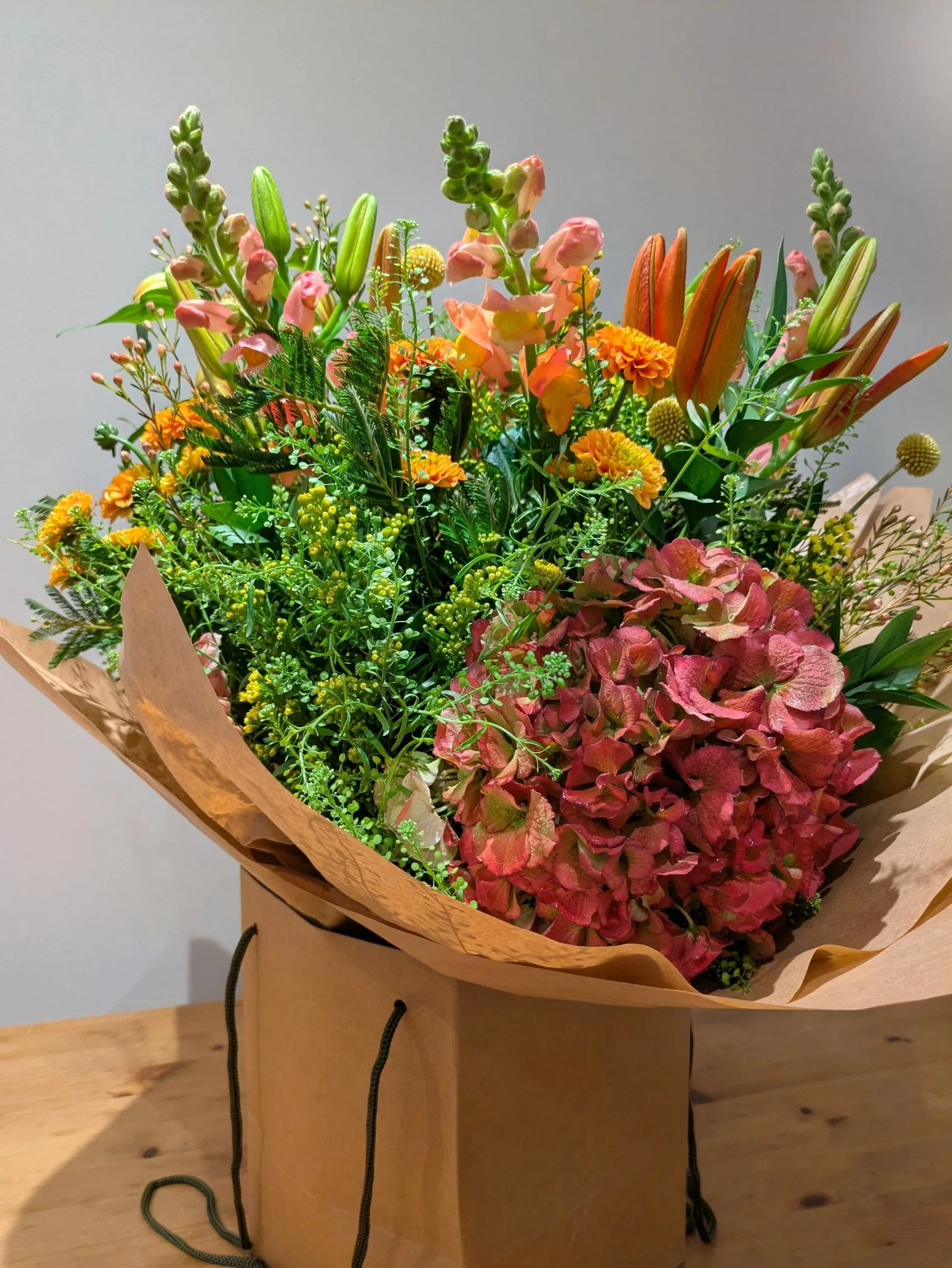 A striking autumn-inspired bouquet with bold seasonal tones and premium blooms. Stylish, long-lasting, and perfect for autumn décor. Thoughtfully wrapped and delivered in a premium floral gift bag.