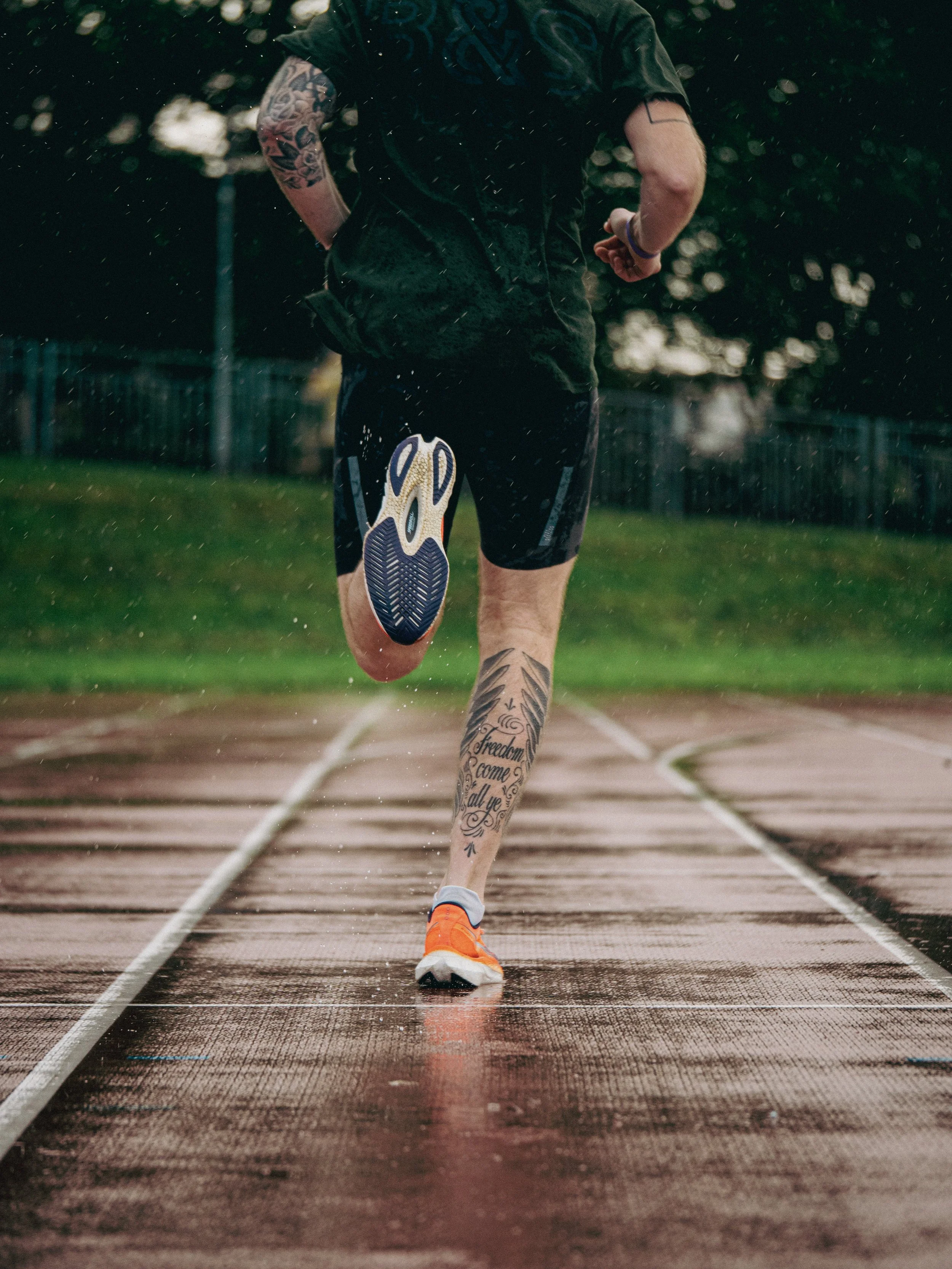 A man running on a running track in Glasgow