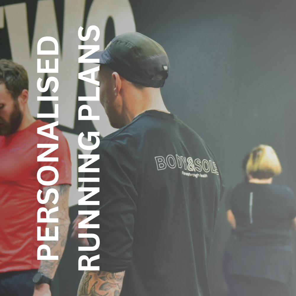 Greig working with a client in the gym to support his in person run coach services in Glasgow