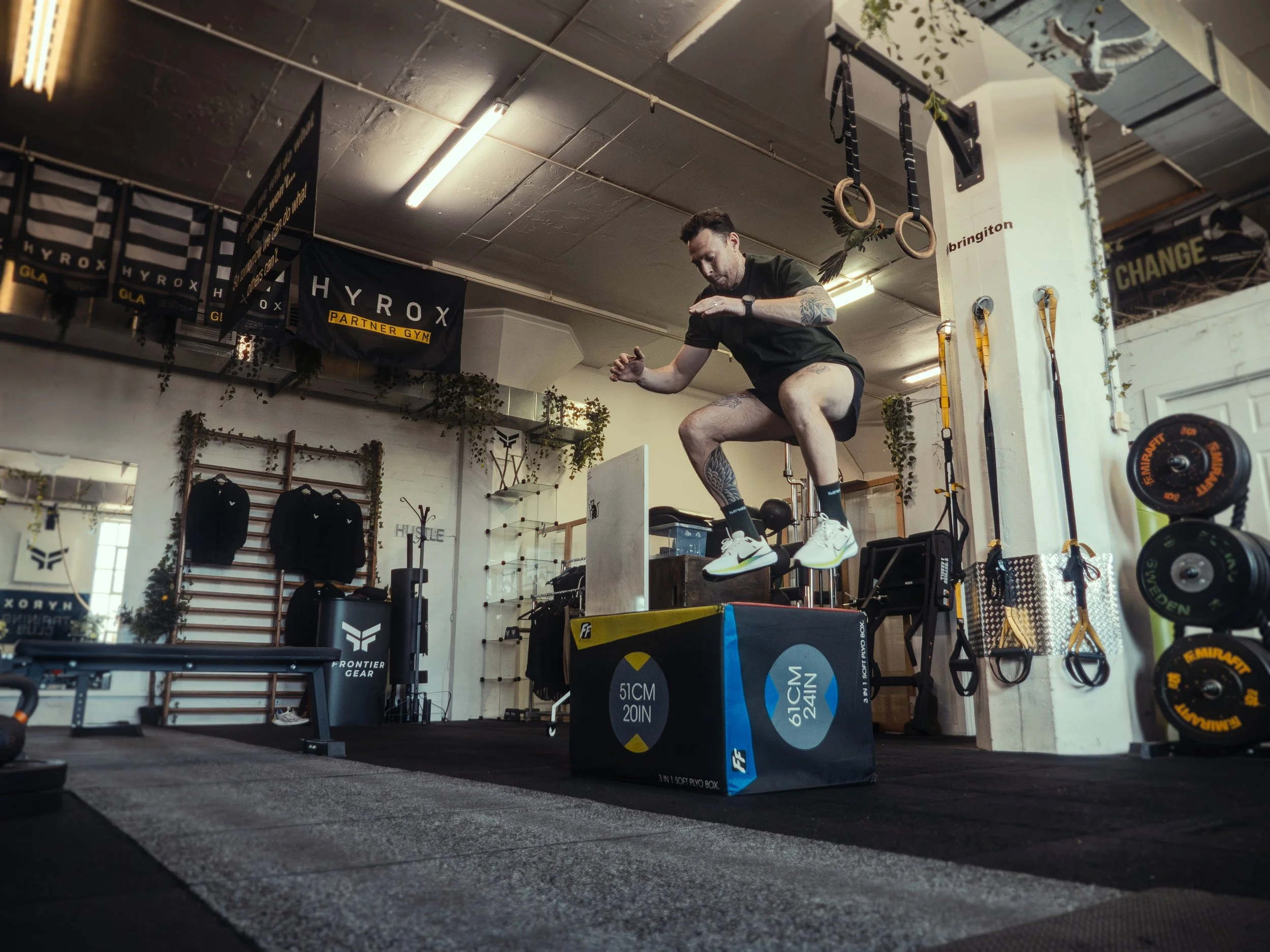 Greig doing a box jump off a gym box