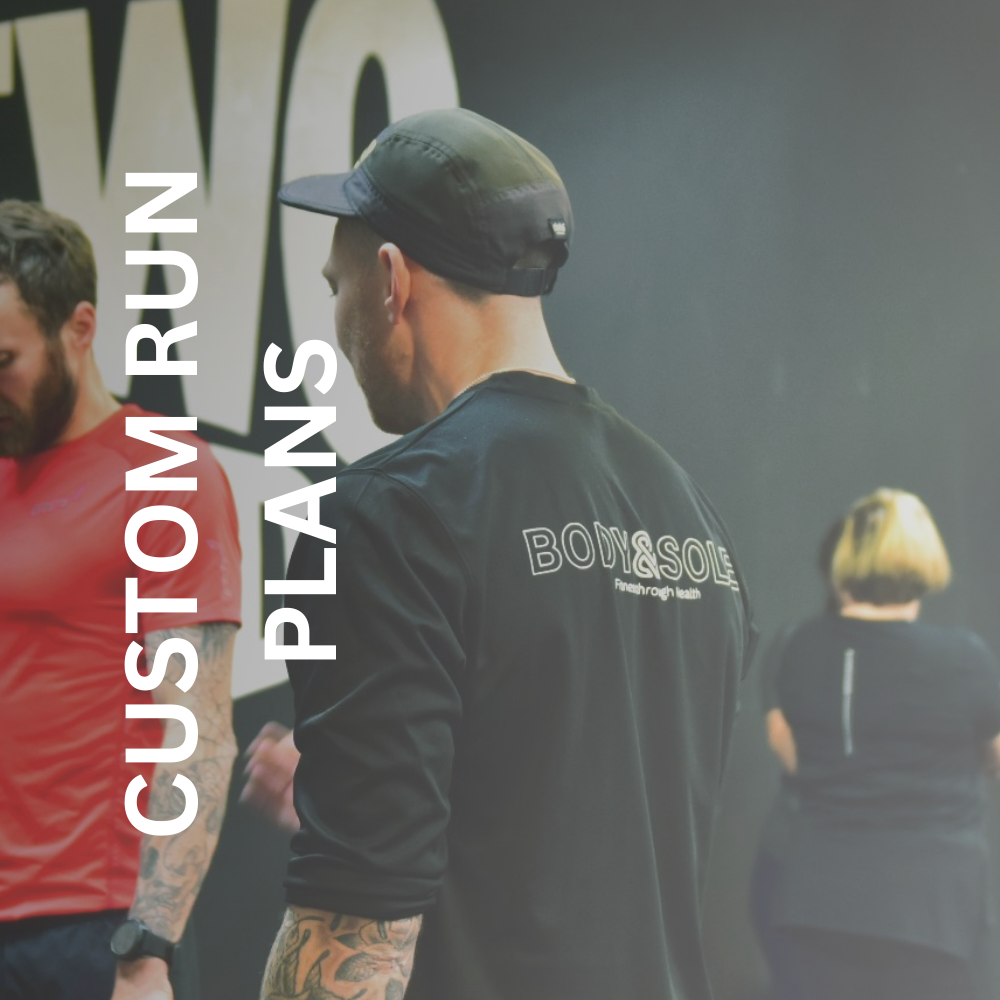 Greig working with a client in the gym to support his run coach services 