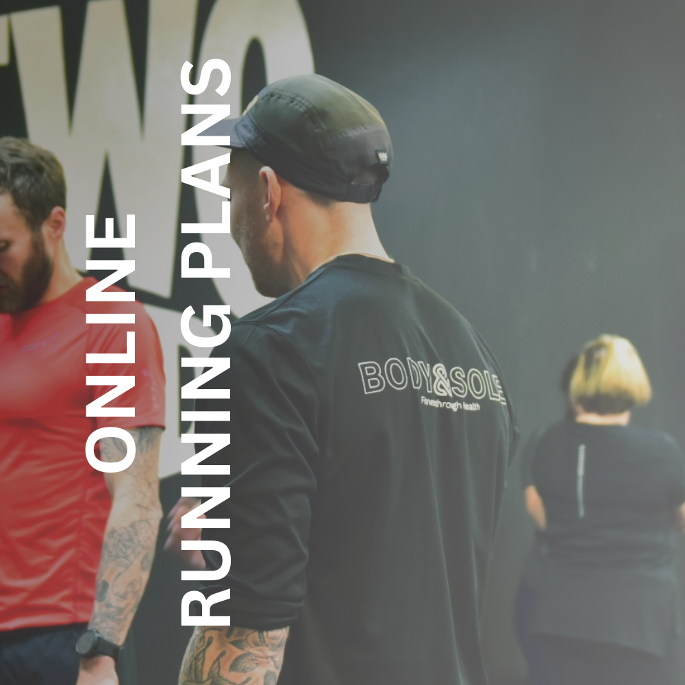 Greig working with a client in the gym to support his run coach services 