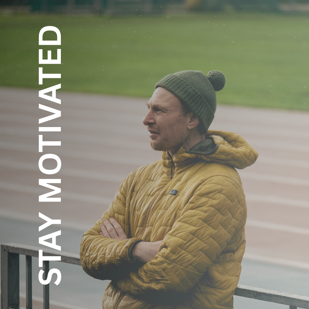 Greig standing on a running track offering run coach services in Glasgow