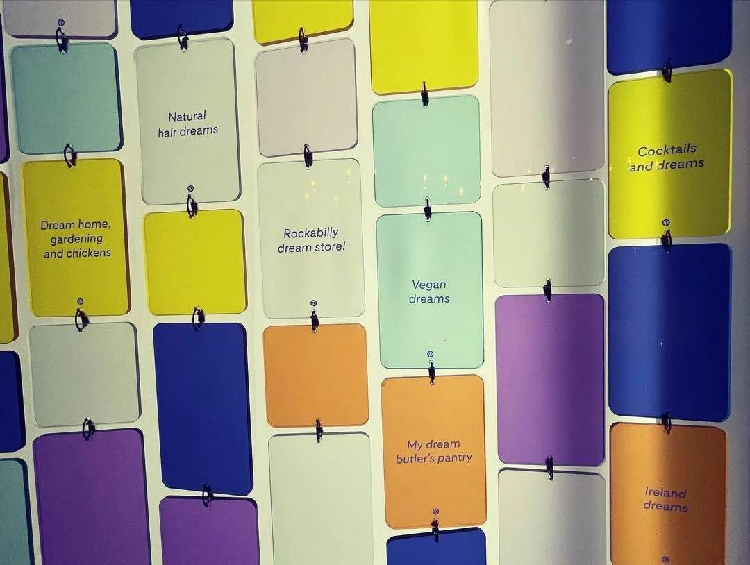 Colorful wall made from acrylic shapes featuring dream board names from Pinterest users around the world.