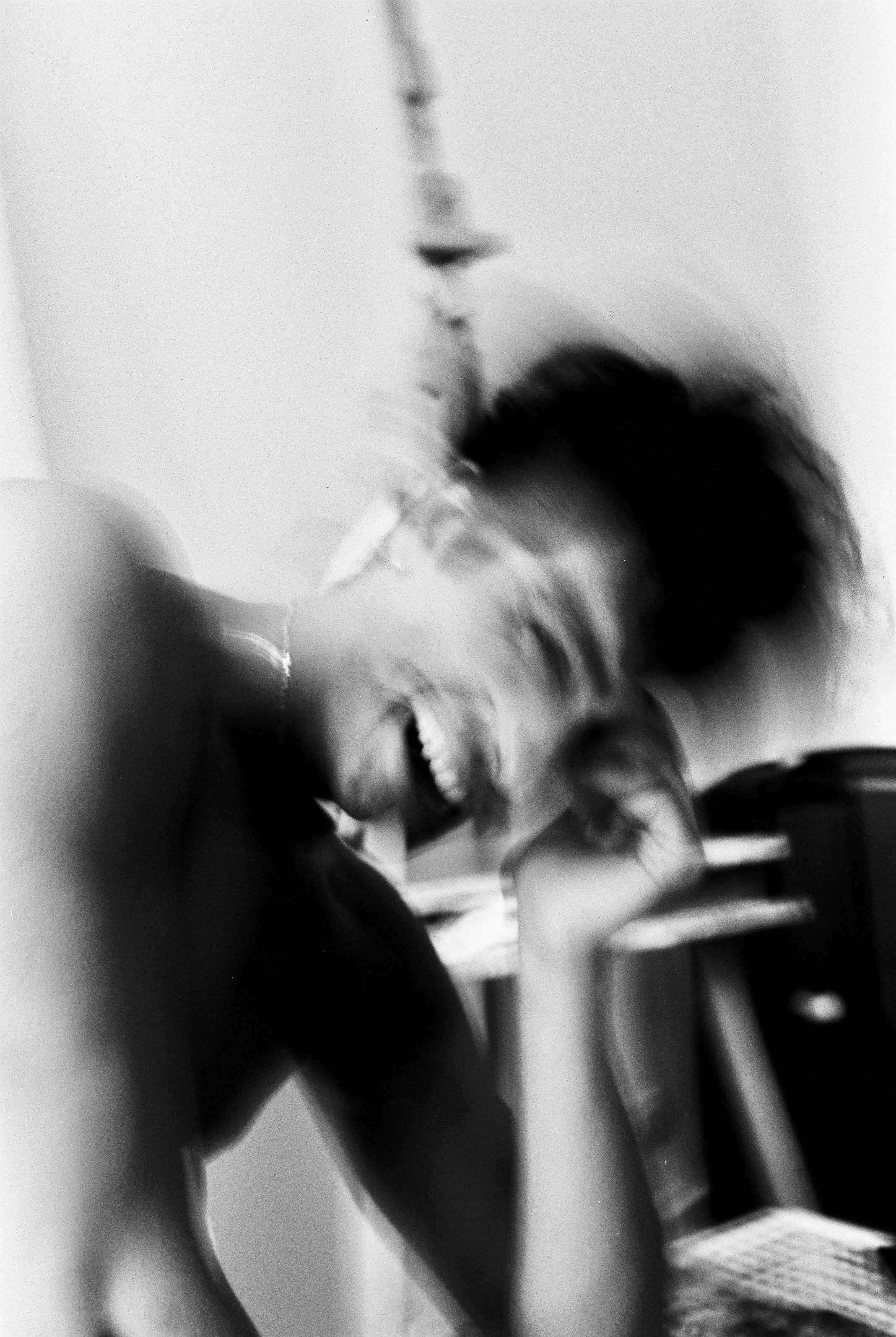 Blurred black and white photo of Angelo laughing.