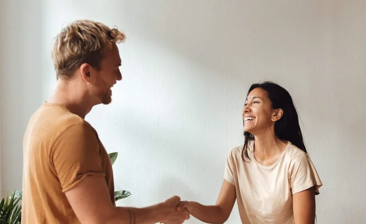Practitioner and client sharing a warm moment during a somatic session in Berlin