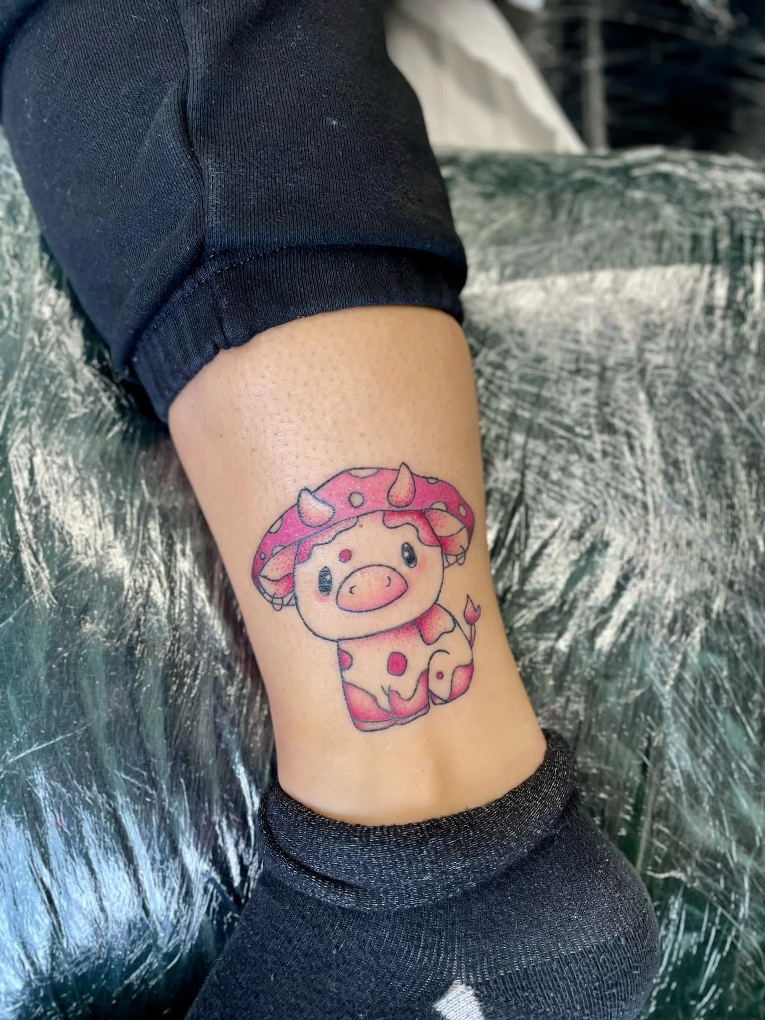 A colour tattoo of a pink mushroom cow