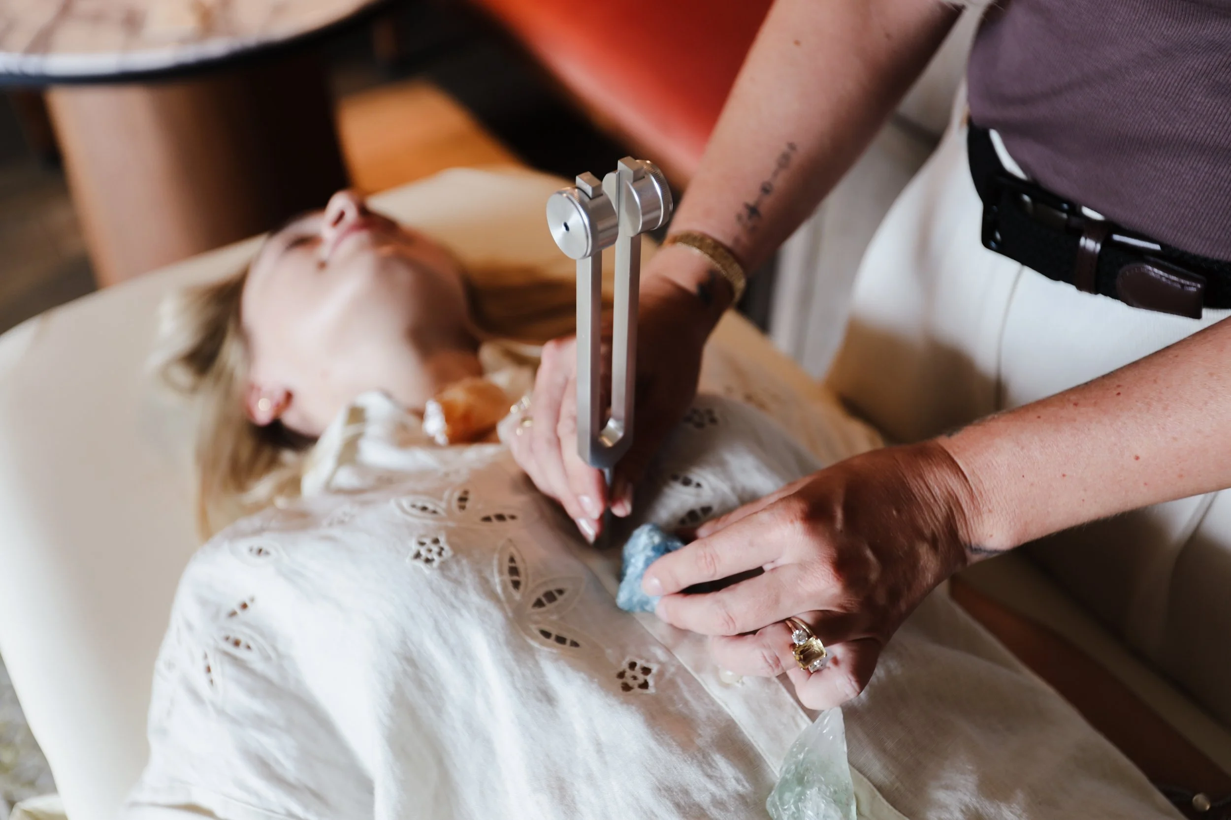 Medical professional preparing to perform or assist with a medical procedure on a patient lying on a hospital bed.
