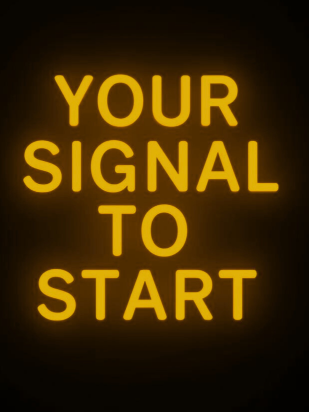 Illuminated sign with yellow text reading 'YOUR SIGNAL TO START' against a black background.