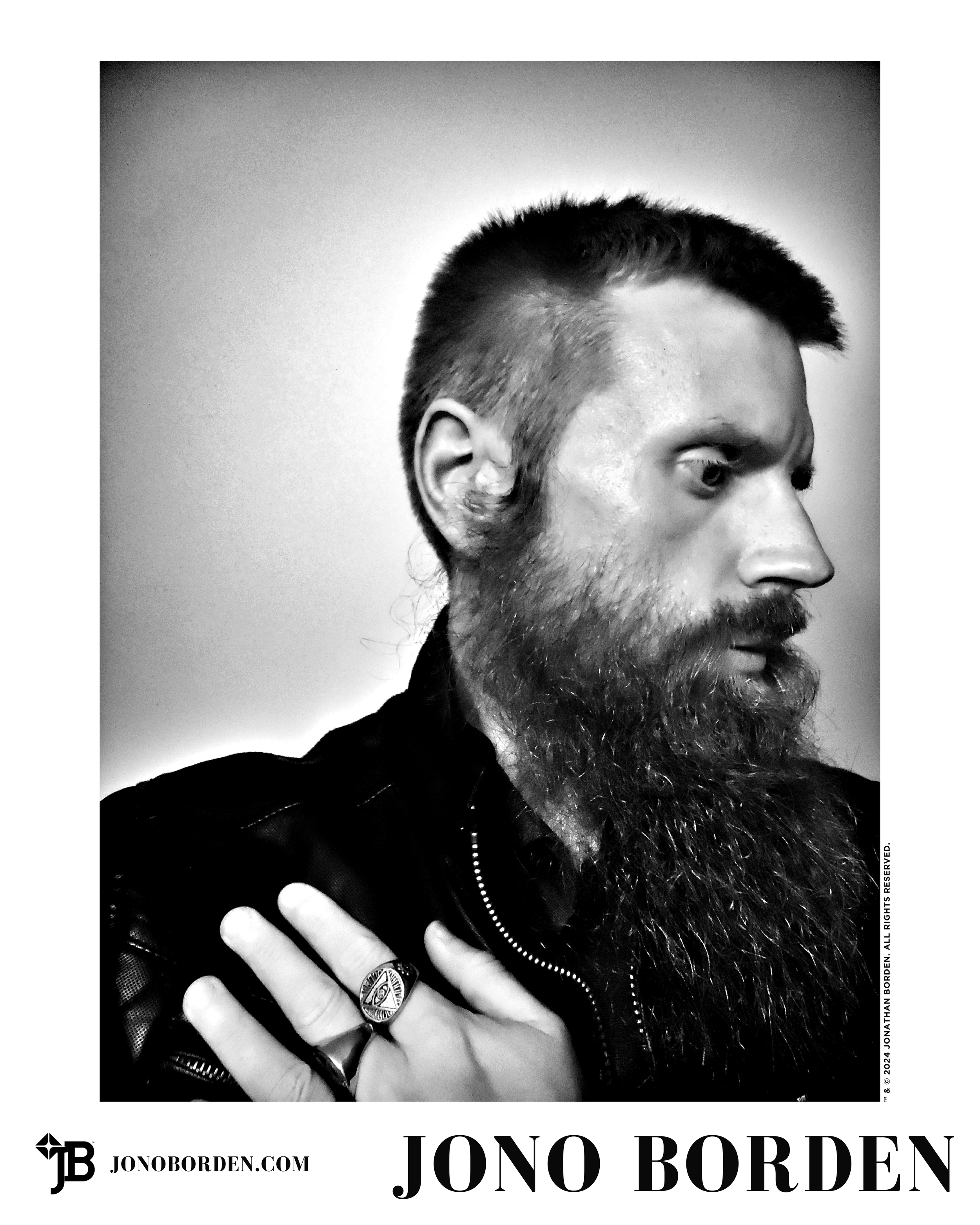 Black-and-white self-portrait of Jono Borden in profile, facing the right of the frame, his nose prominent, his beard long, wearing a leather jacket and large silver rings, his left hand on his right shoulder, taken of himself in 2020.