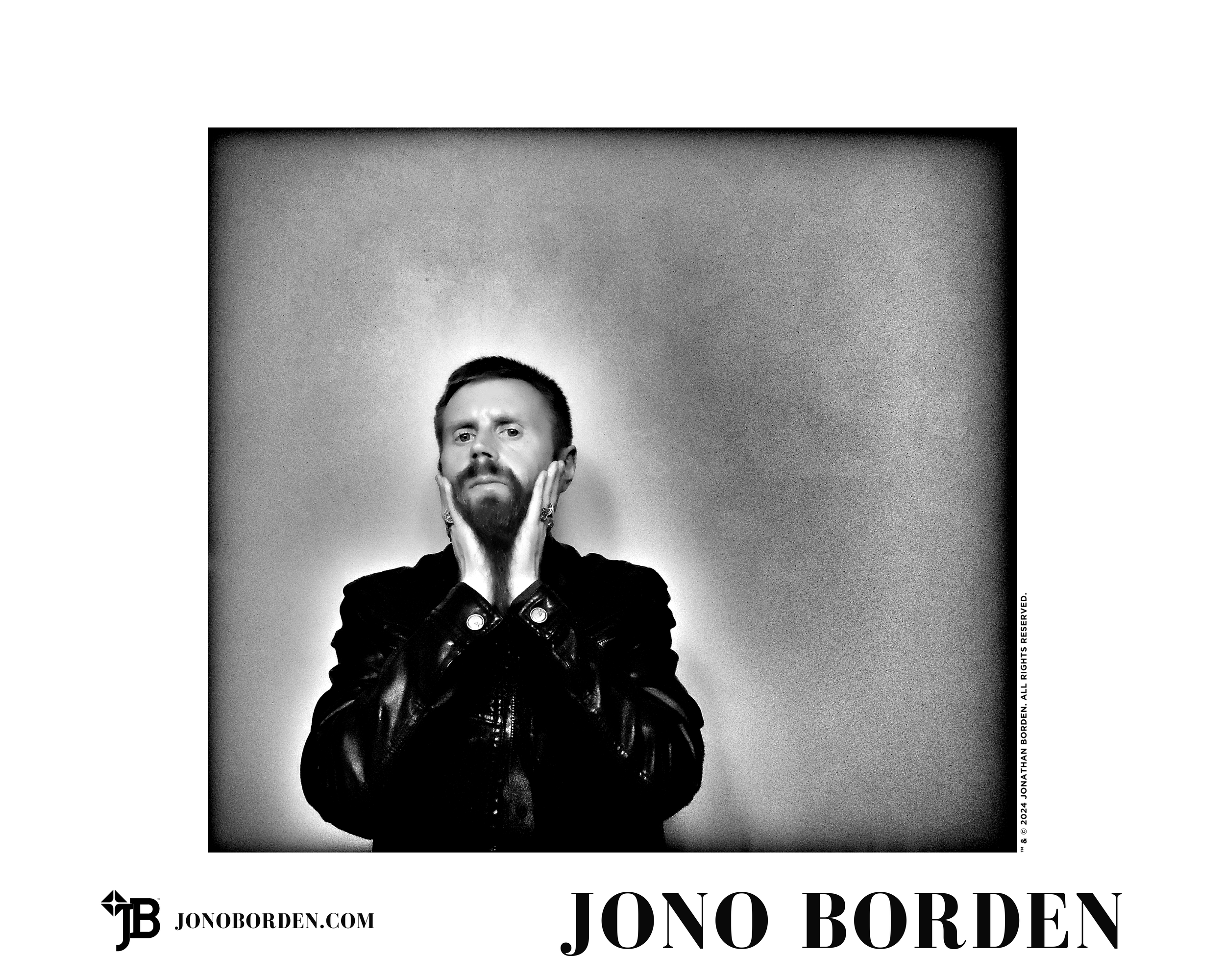 Black-and-white self-portrait of Jono Borden facing the viewer, wearing a leather jacket, many large silver rings, with his hands on his cheeks, holding down his long beard, taken of himself in 2020.