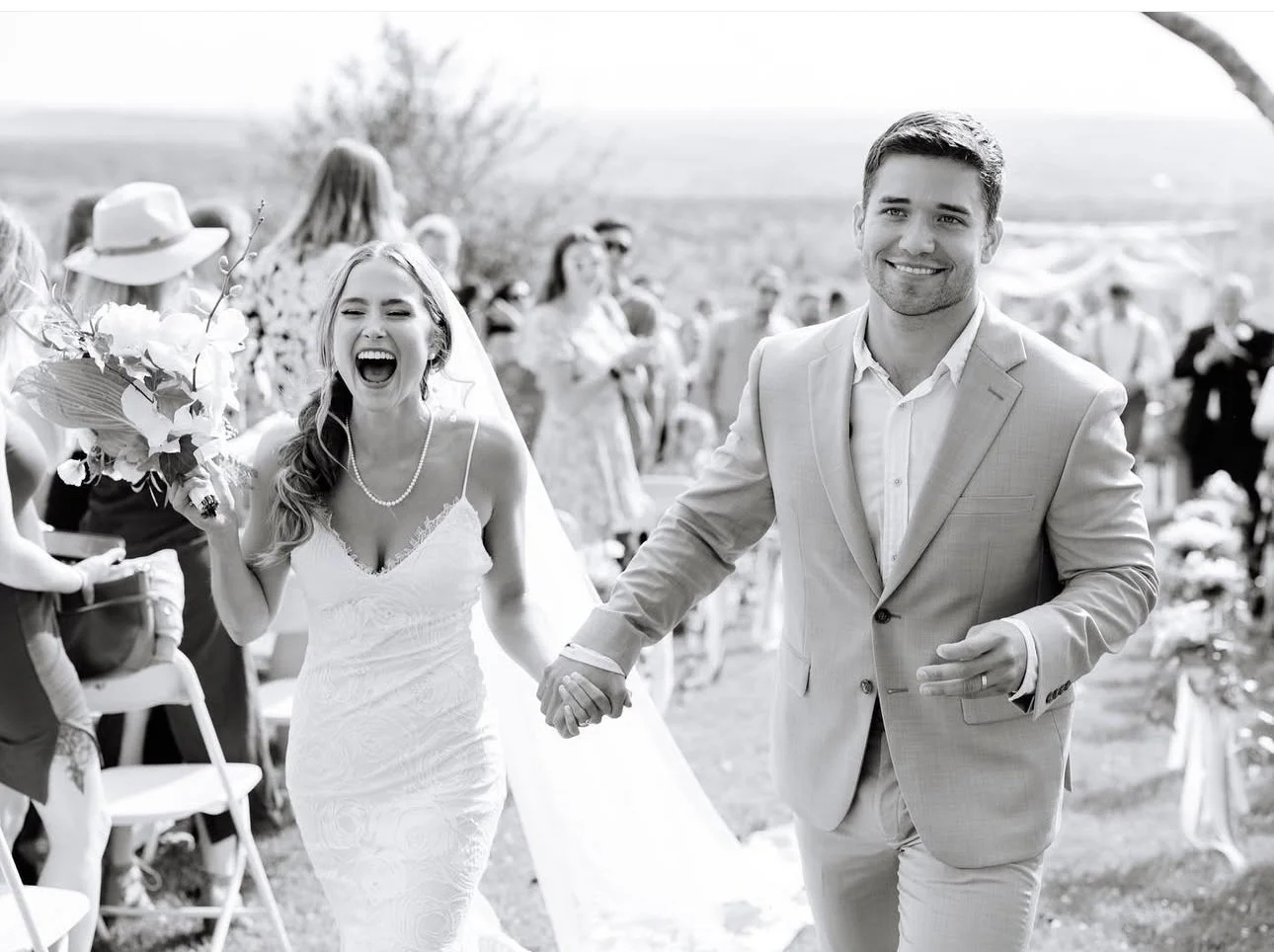 The bride and groom celebrating at their outdoor wedding planned by Anne.