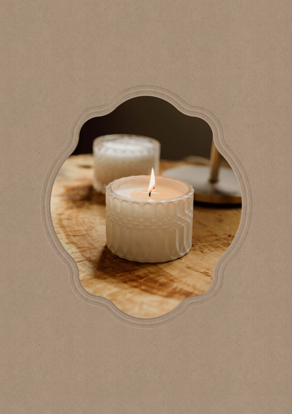 An Opal & Fawn candle in a vintage paper frame.