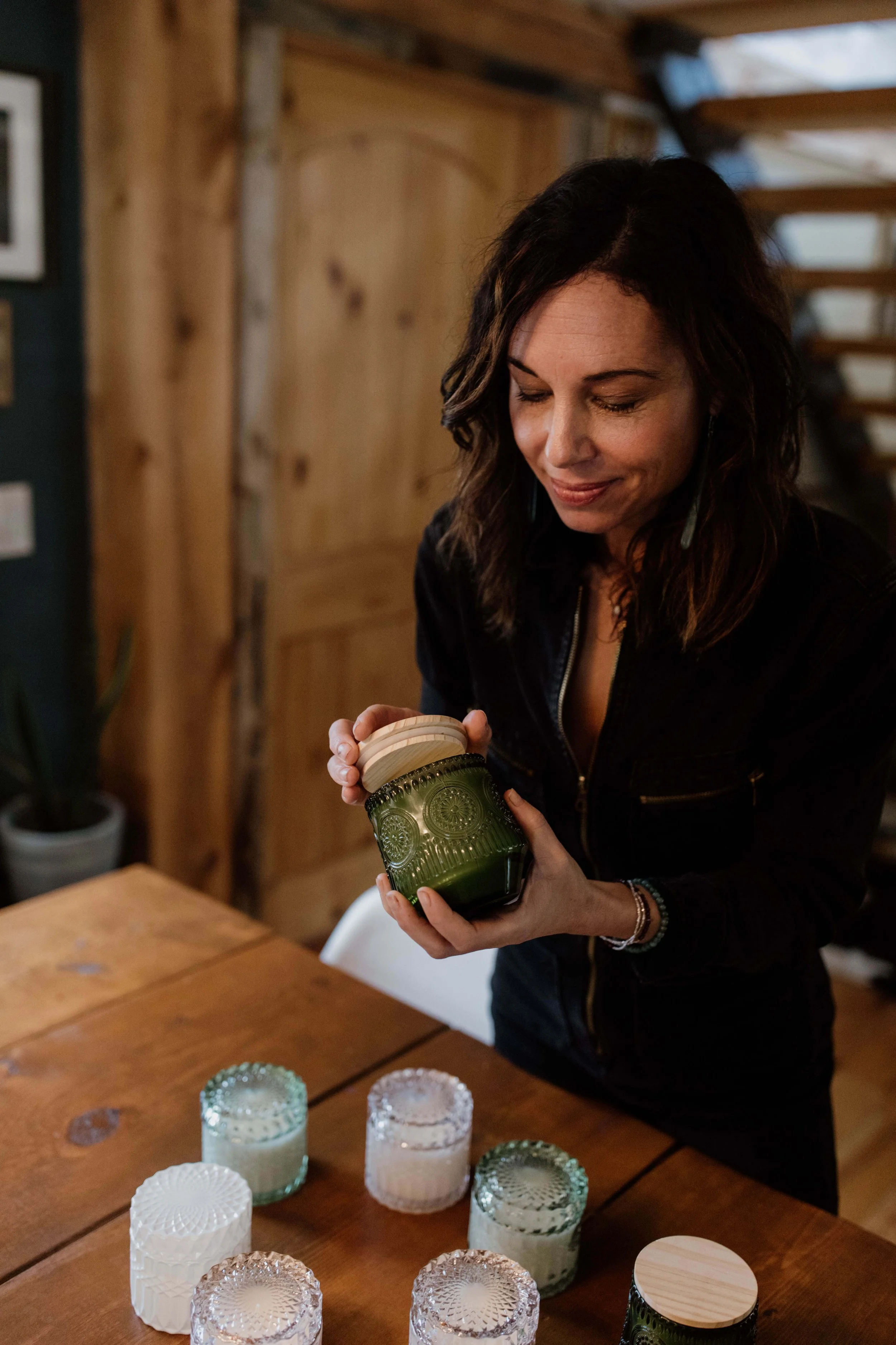 Anne opening the lid of a candle.