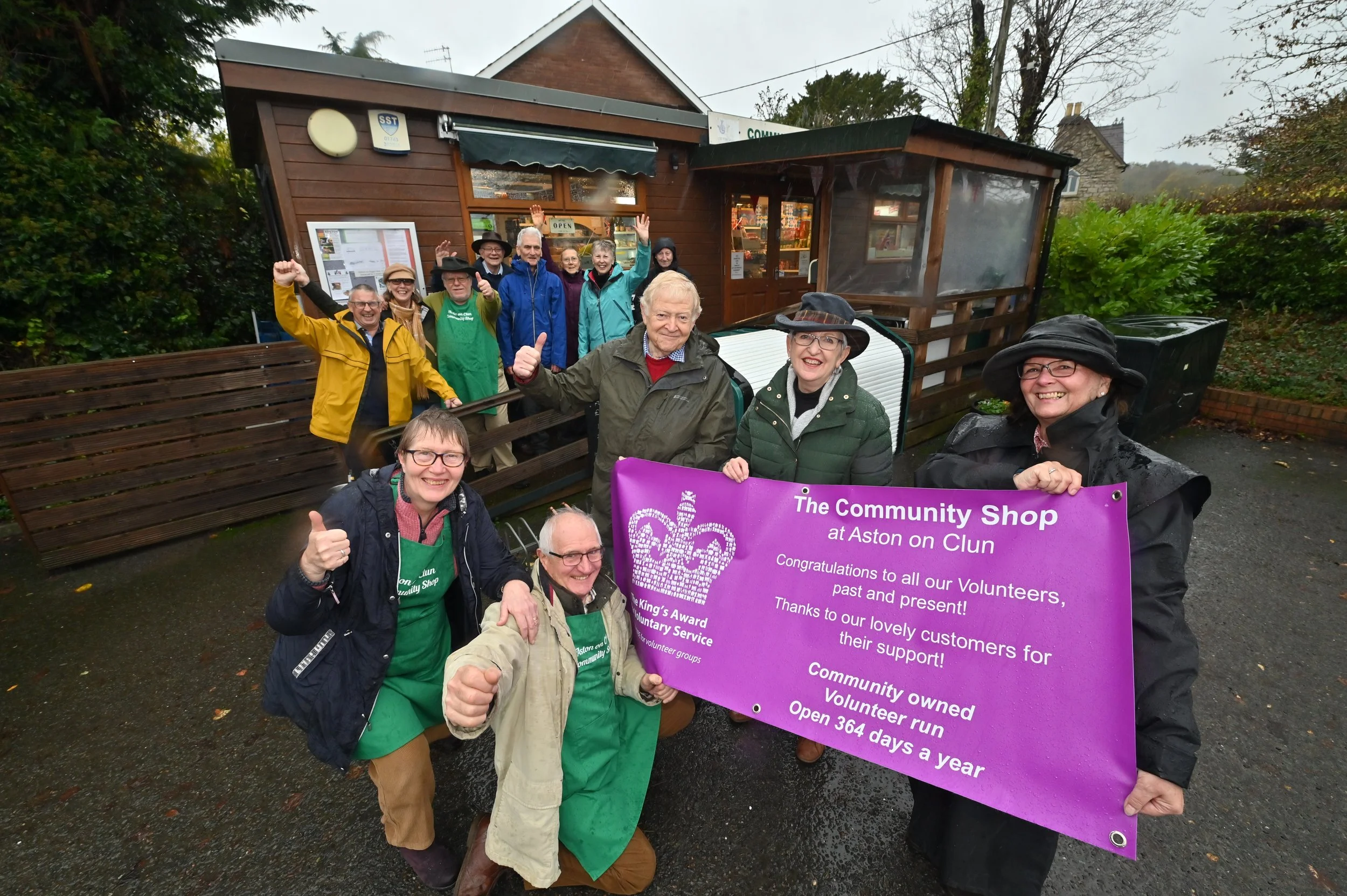 photo of volunteers with King's award banner