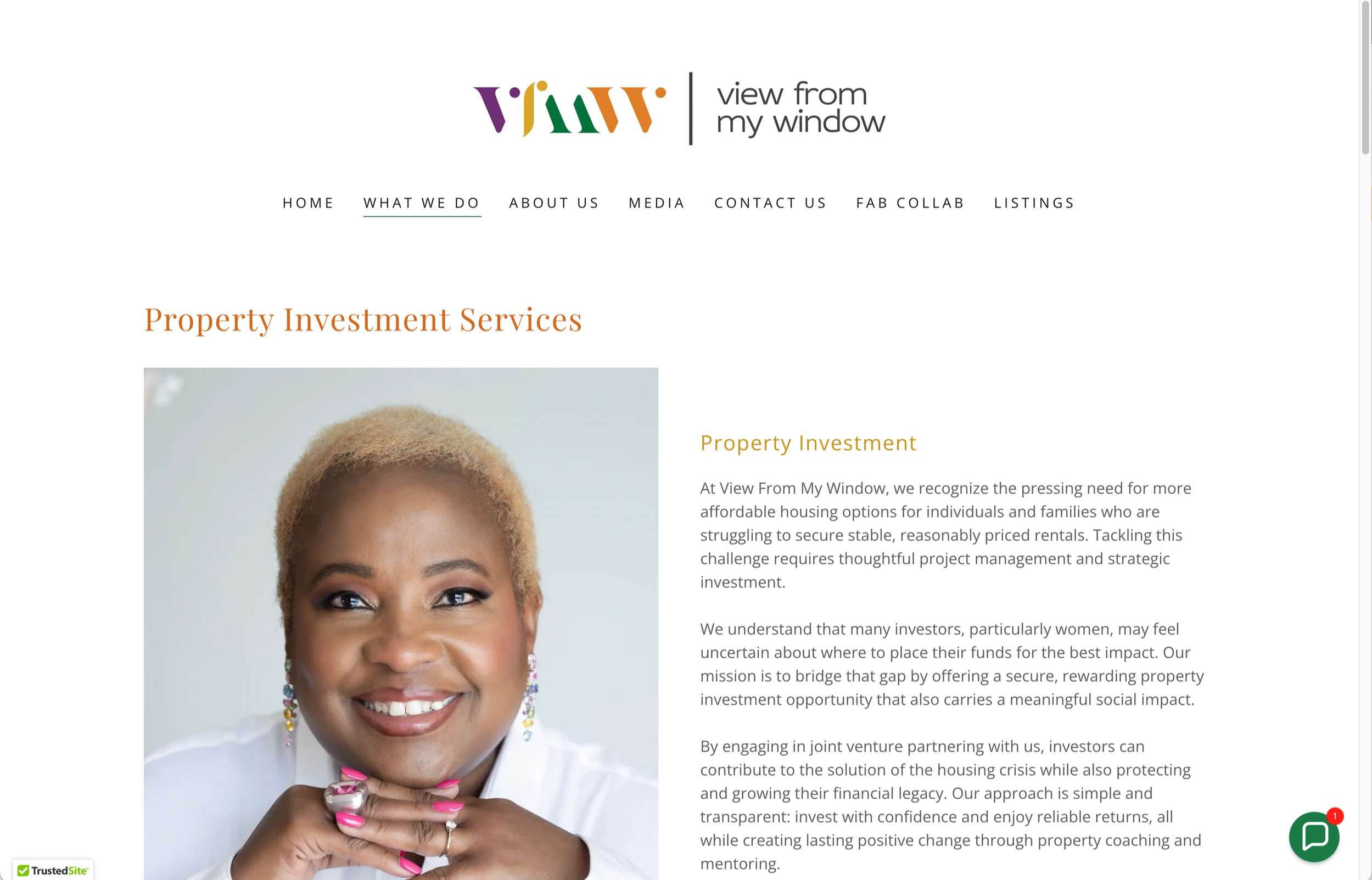 A website screenshot from View From my Window featuring a close-up of a smiling woman with short blonde hair and jewellery, resting her chin on her hand.