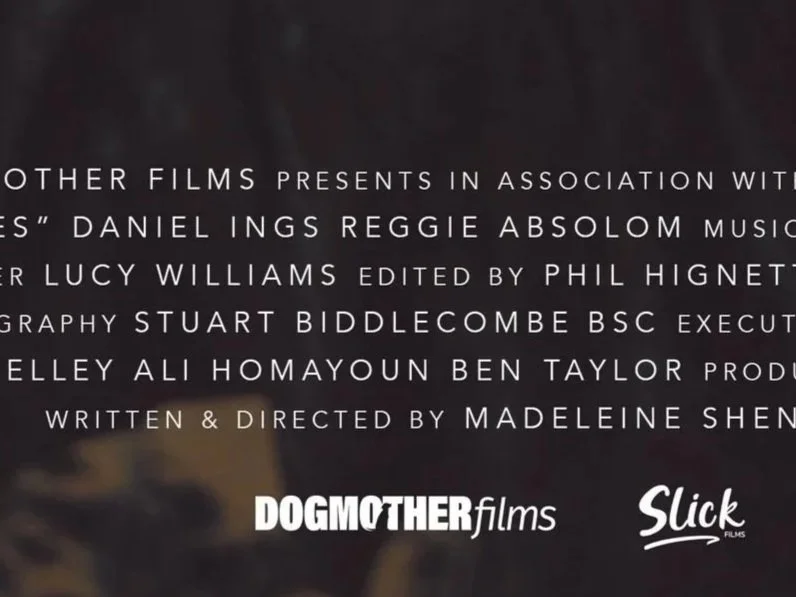 Screen capture of a film credits scene with text mentioning production companies Dogmother Films and Slick Films, and names of individuals involved.