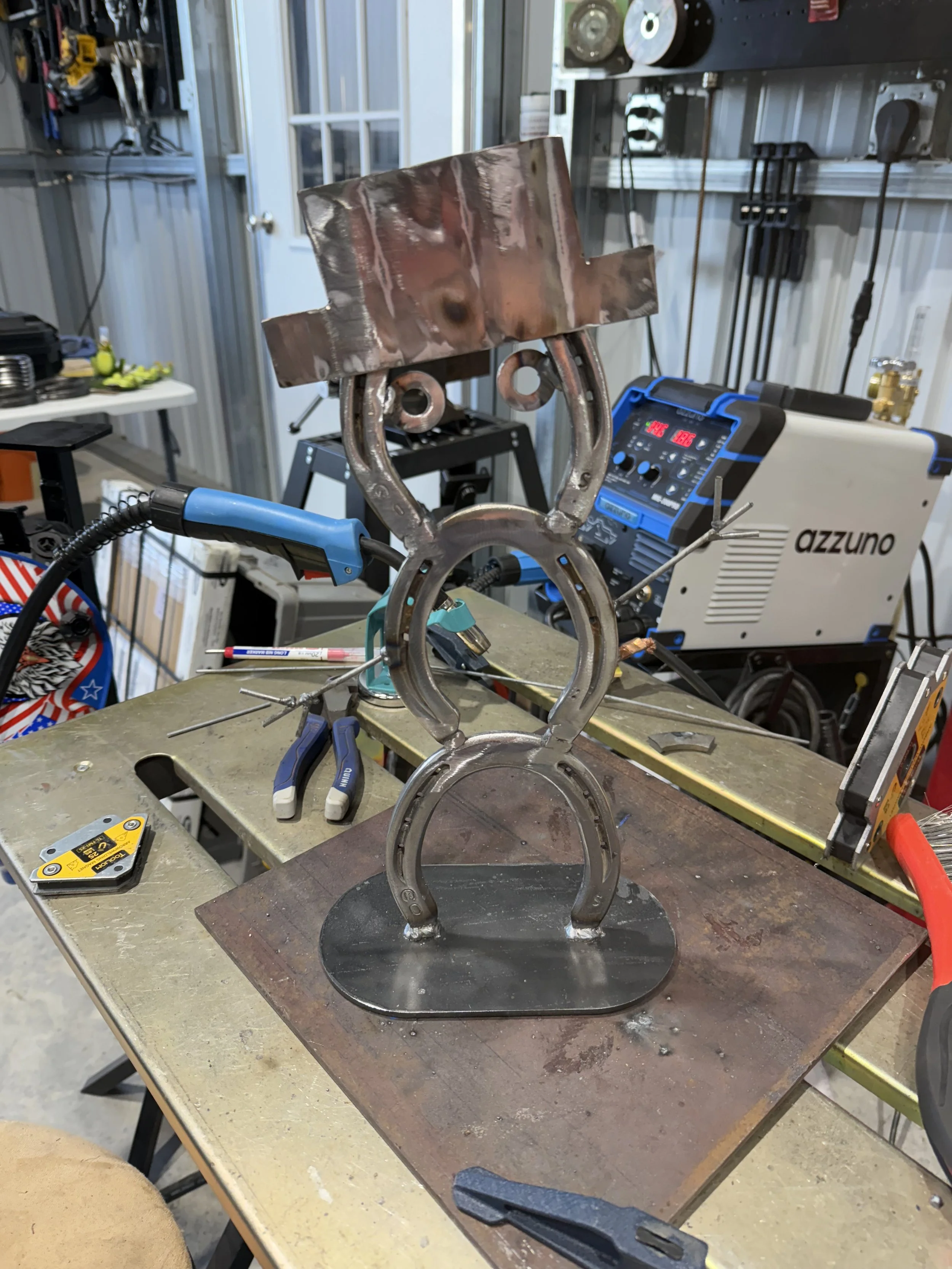 Unfinished snowman out of horseshoes