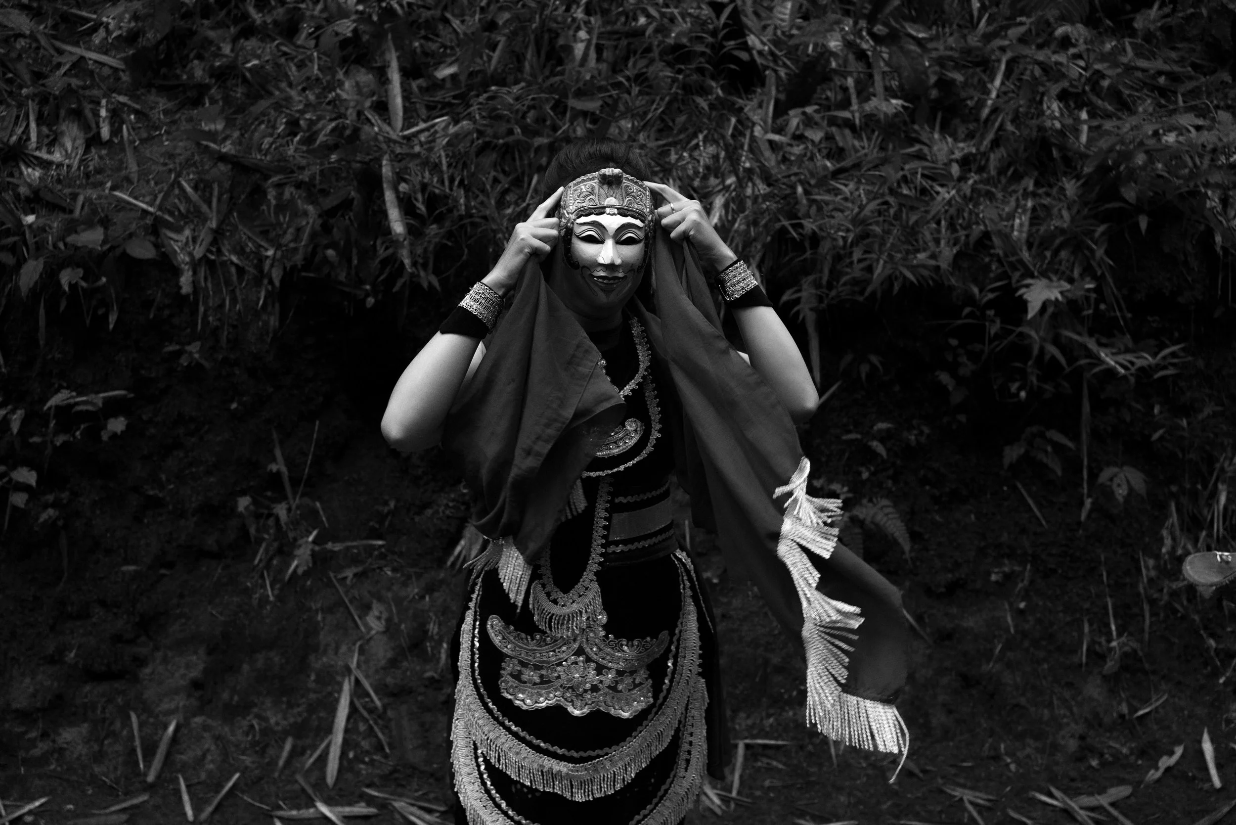 Topeng Malang dancer adjusting mask backstage before Bersih Desa ceremony. Malang East Java