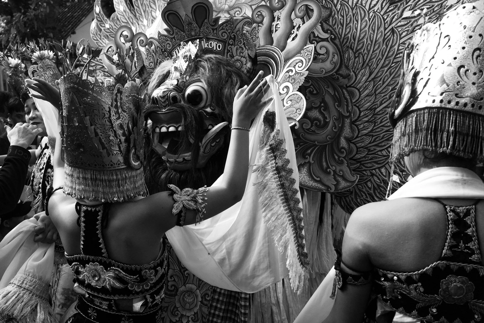 Gandrung dancers performing with a large decorative lion or dragon head costume in the background, Banyuwangi East Java