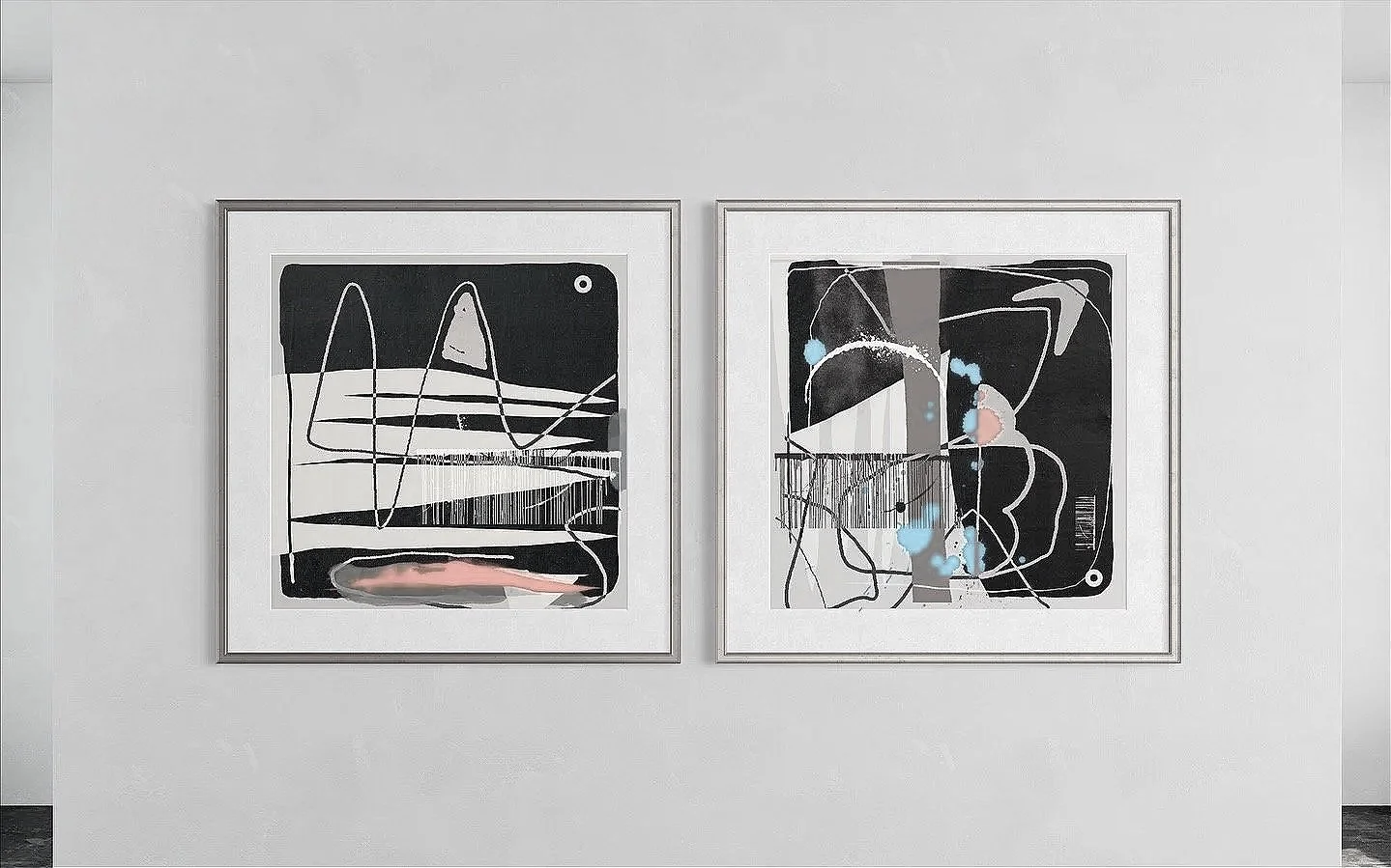 Two abstract paintings with black backgrounds, white, gray, orange, and blue lines and shapes are displayed in simple beige frames on a white gallery wall.