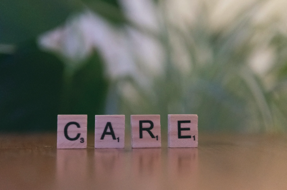 Scrabbe tiles spelling out CARE