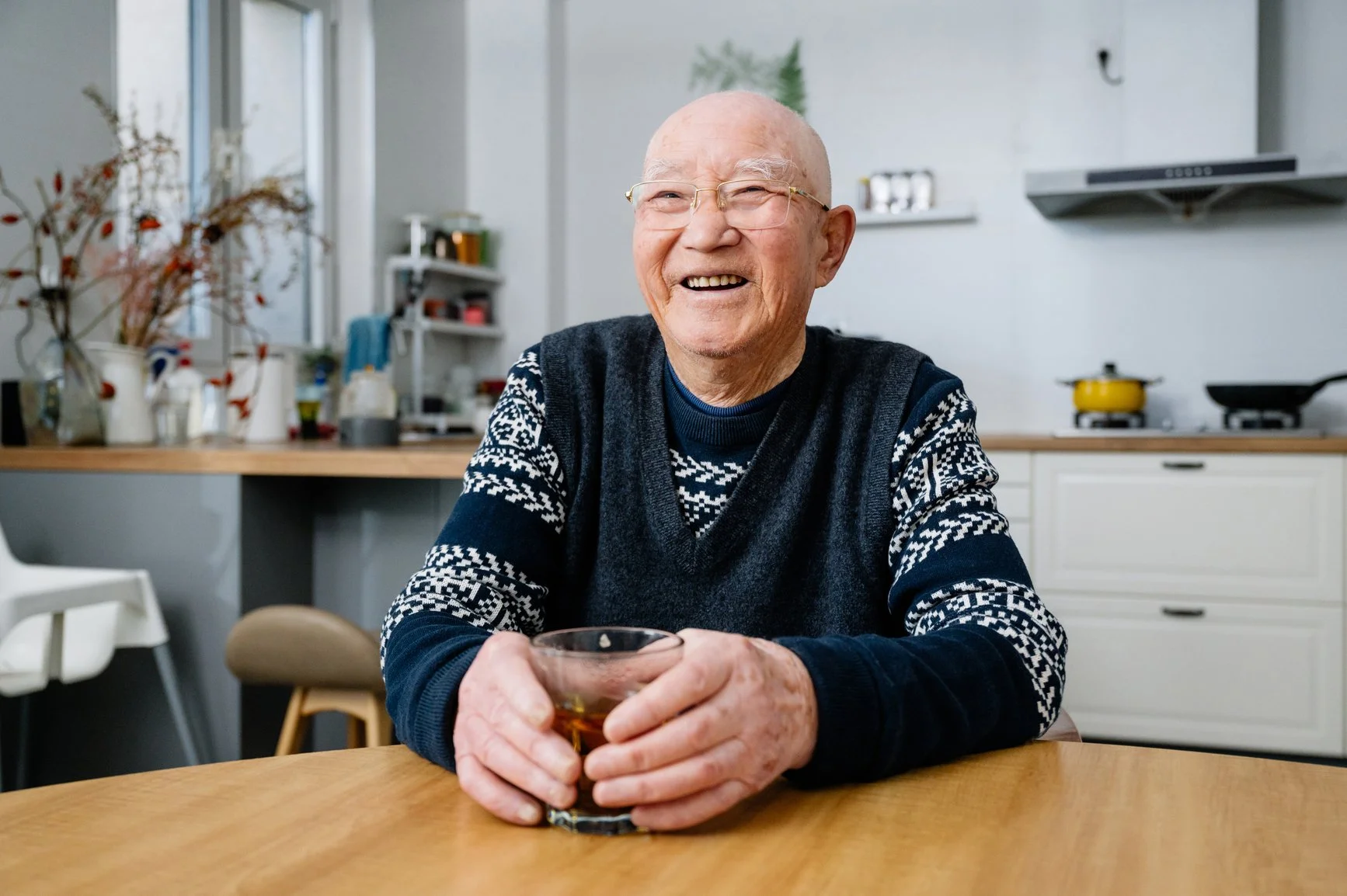 An elderly man smiling in his kitchen using the hourly care service in Hertfordshire