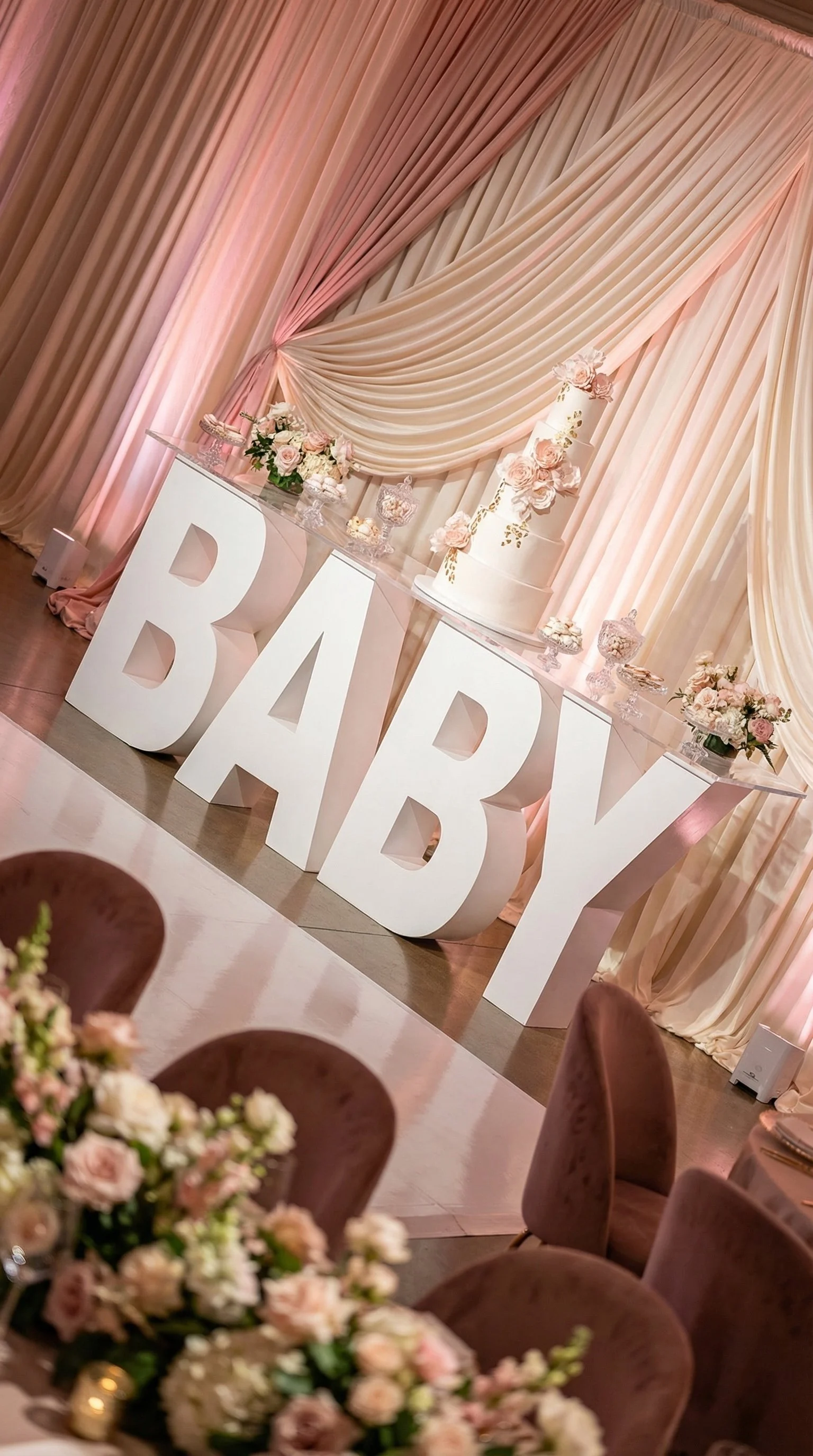 Baby shower marquee letters in DMV.  large white 'BABY' letters, pink and cream floral arrangements.