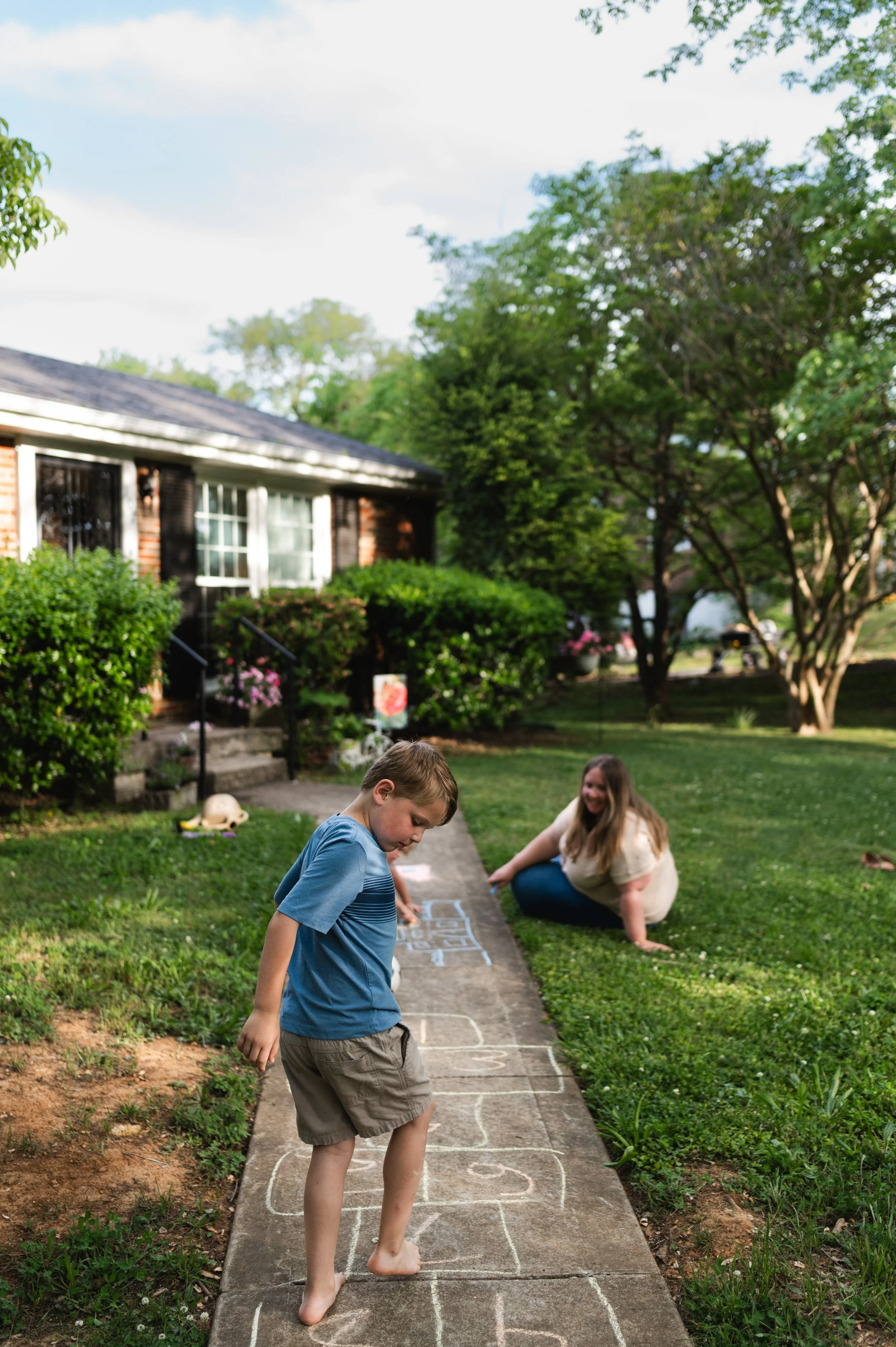 boy plays hopscotch, home session, family photographer, motherhood photographer, affordable, nashville tn, clarksville tn