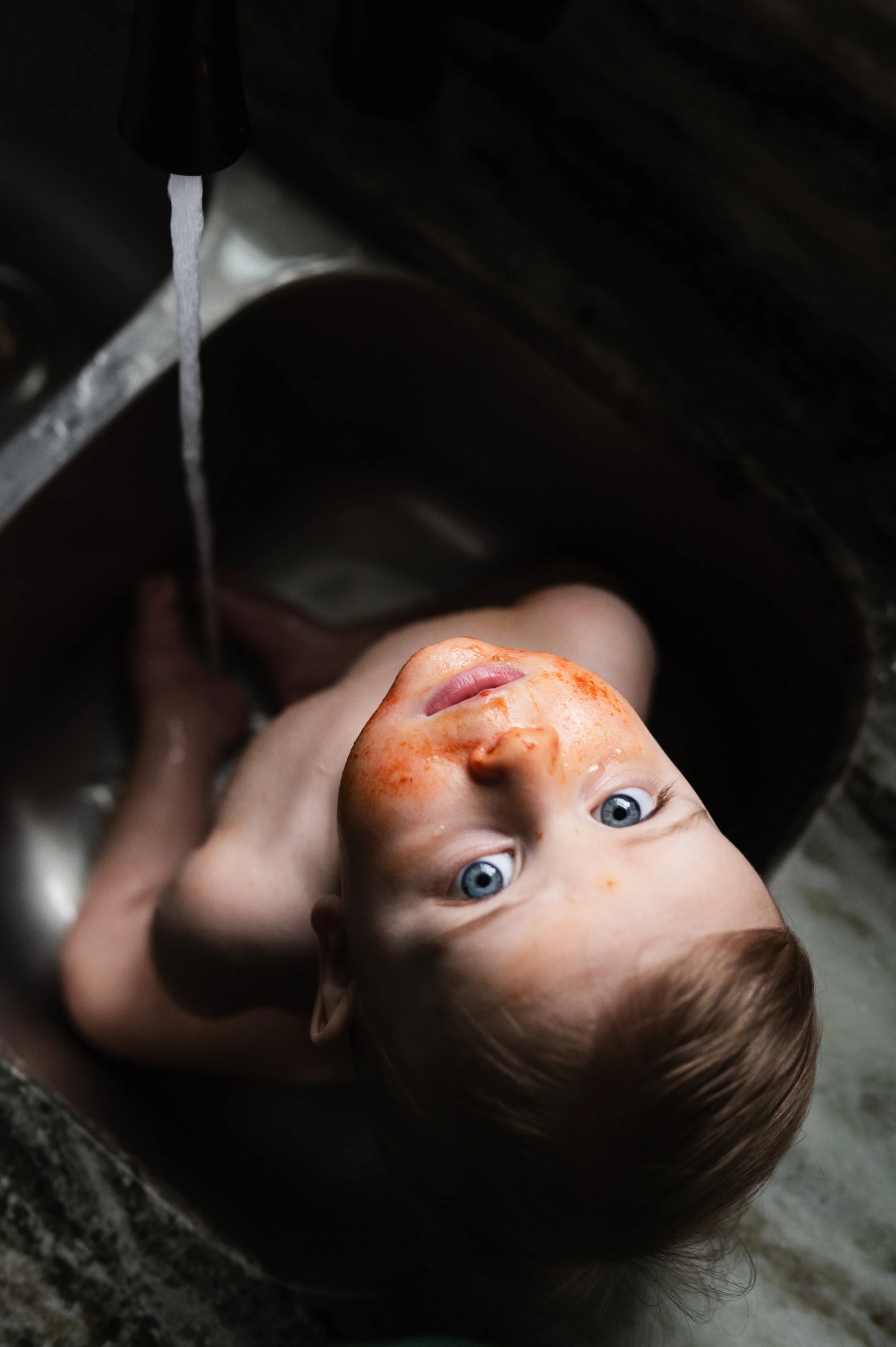 young child in sink, photographer, milestone photos, family photos, clarksville and nashville tennessee, moody, affordable, in-home session