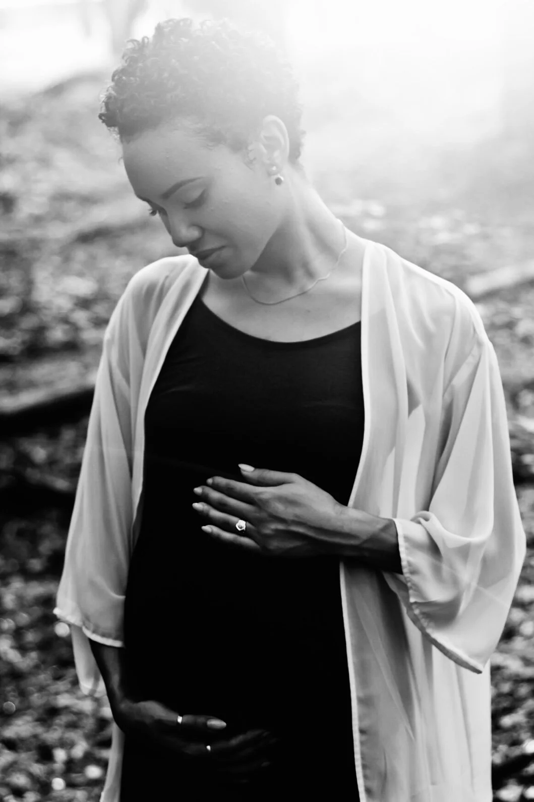 back-lit black and white portrait of pregnant woman holding bump, clarksville tennessee, clarksville tn maternity photographer, maternity and newborn photographer, affordable, nashville tn, photographer, lifestyle maternity photographer