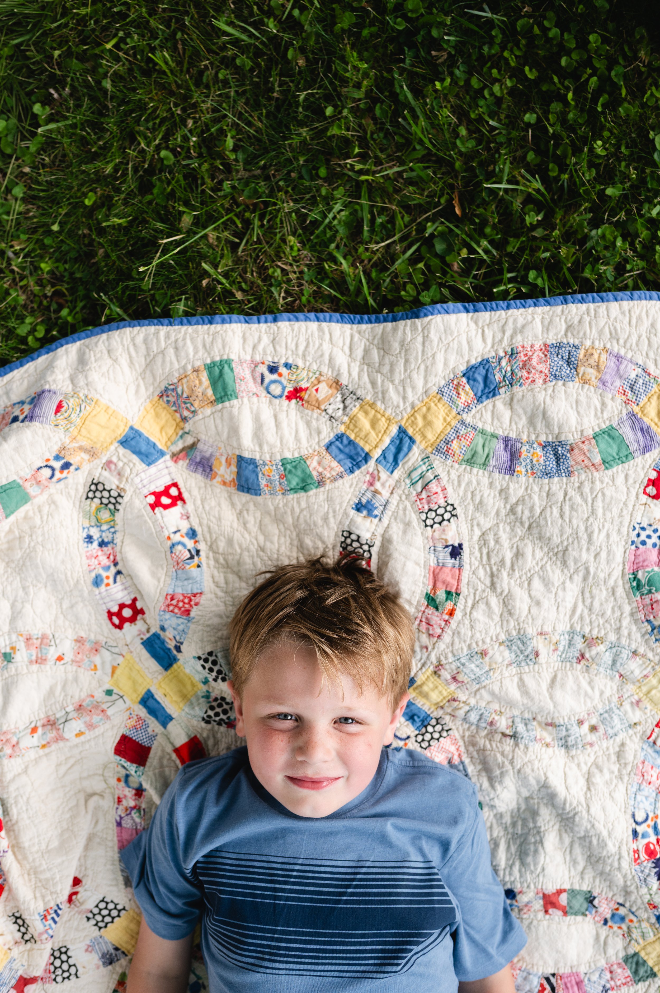 boy laying on quilt, storytelling family photography, family photographer clarksville tennessee, family photographer nashville tennessee