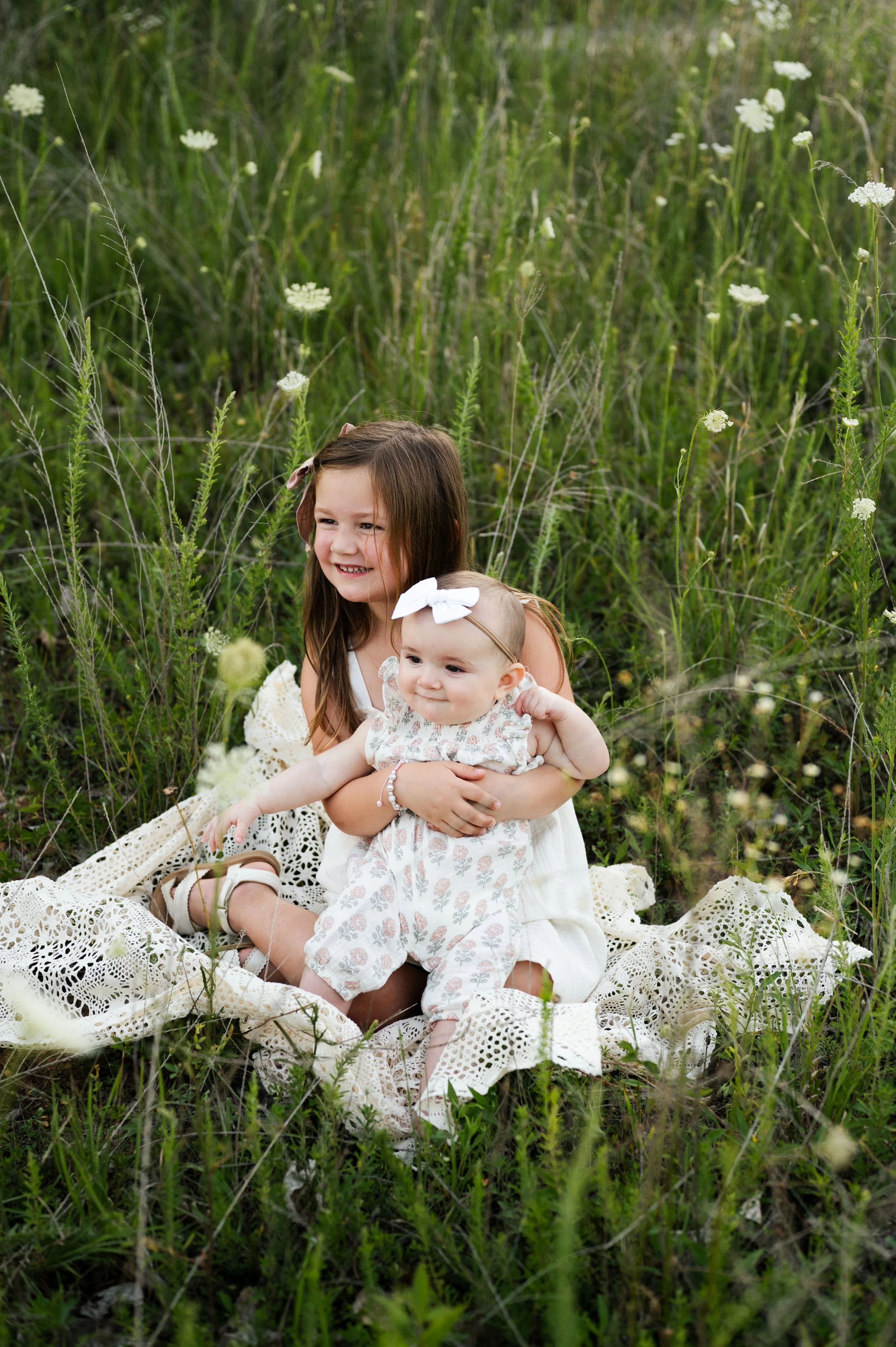 child and baby sit in flower field, family photographer, nashville, affordable, clarksville tennessee