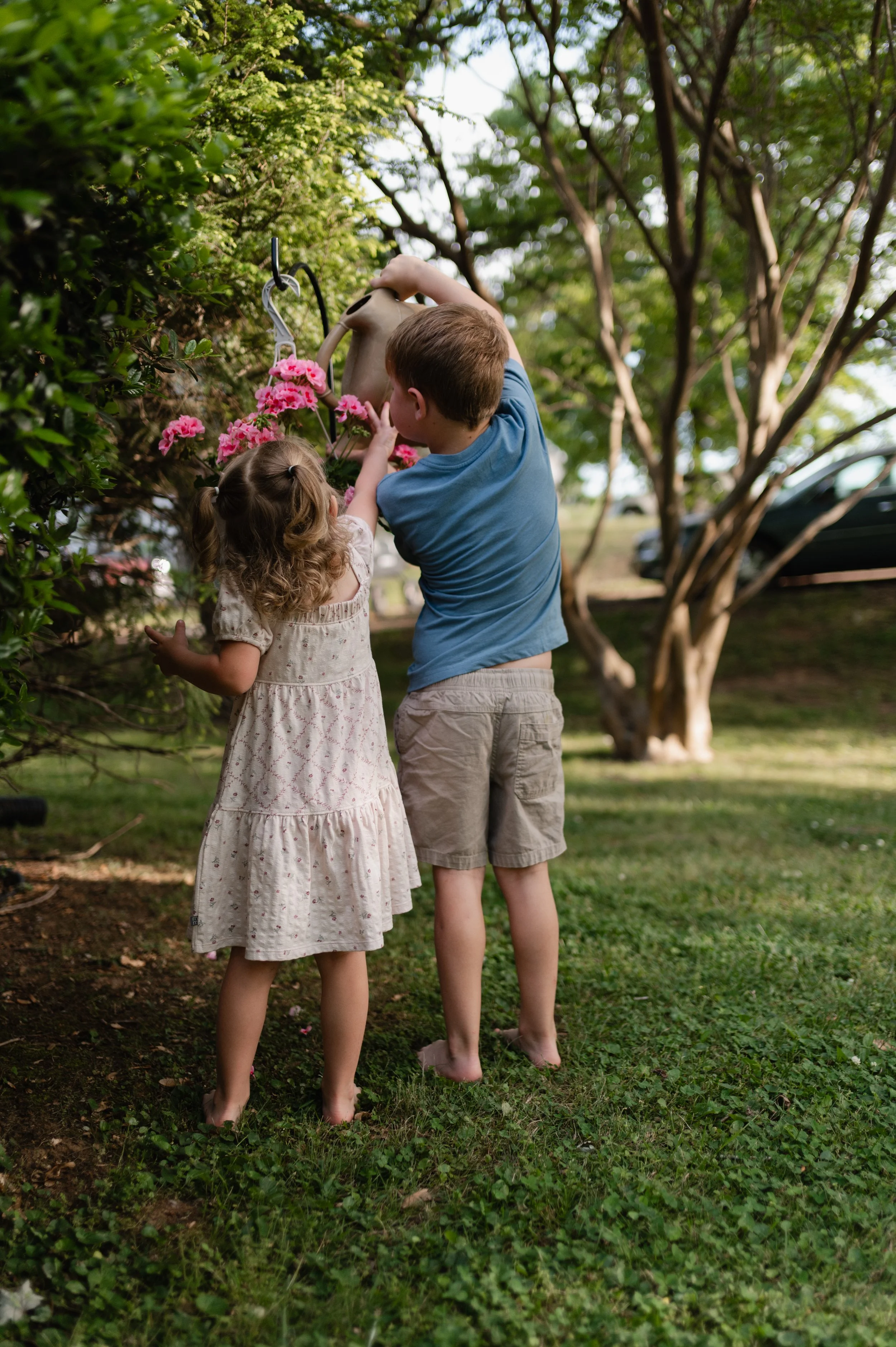 boy and girl water flowers, candid family photos, storytelling family photographer, family photographer, clarksville tn, nashville tn
