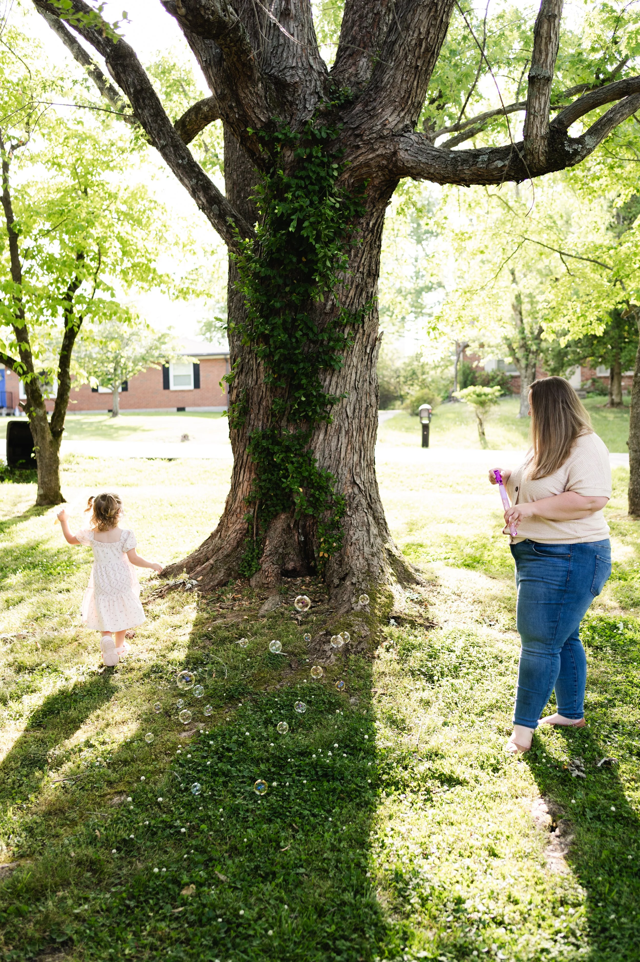 mother and daughter play in yard, family photographer clarksville tn, family photographer nashville tn, affordable