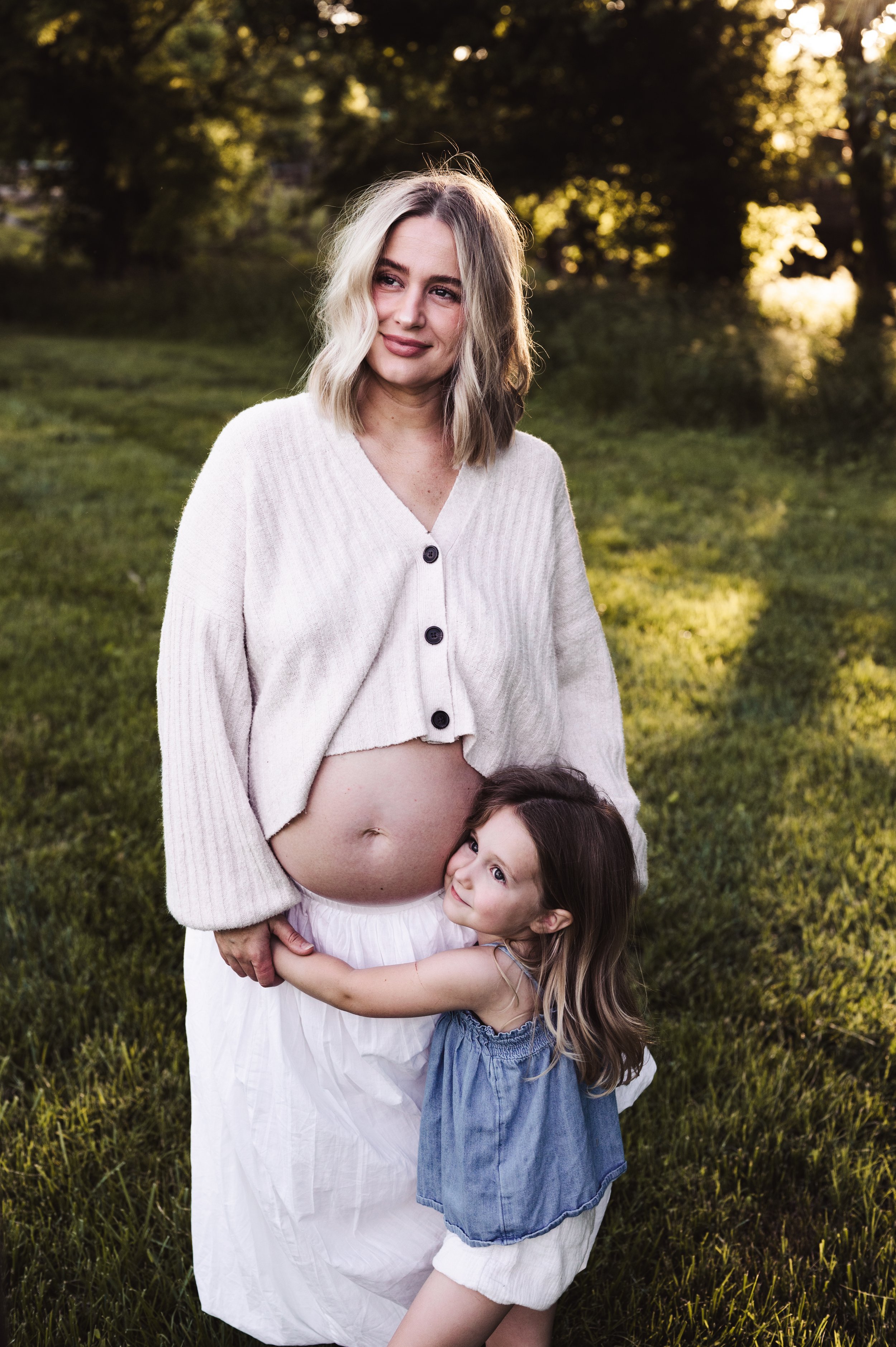 pregnant mother hugging daughter outdoors at sunset, clarksville tn photographer, affordable, maternity, photography, maternity photography, motherhood photography, mother and daughter, mommy and me, family maternity photos