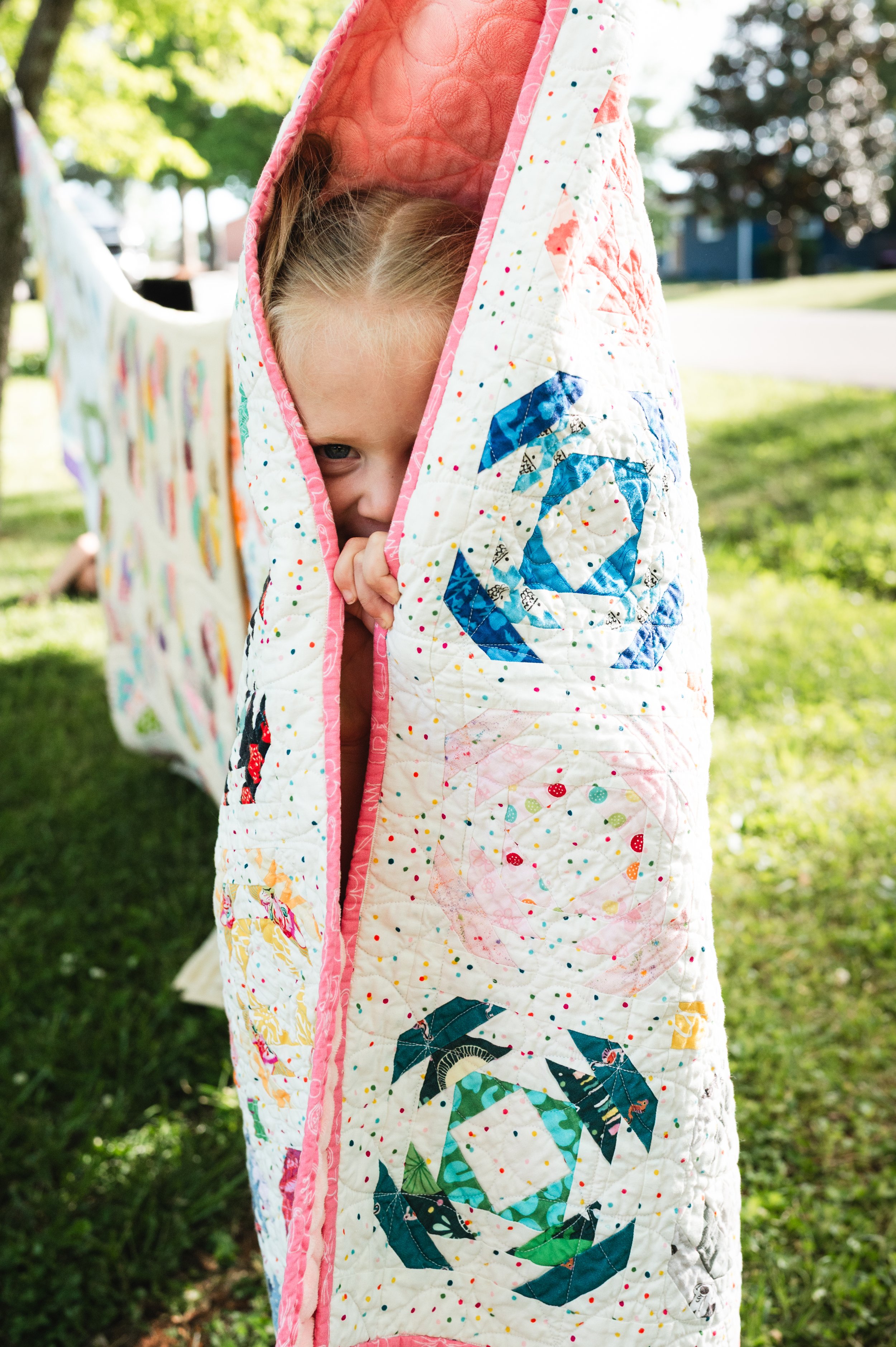 girl hides in quilt, at home session, family photos, nashville tn photographer, clarksville tn photographer, affordable