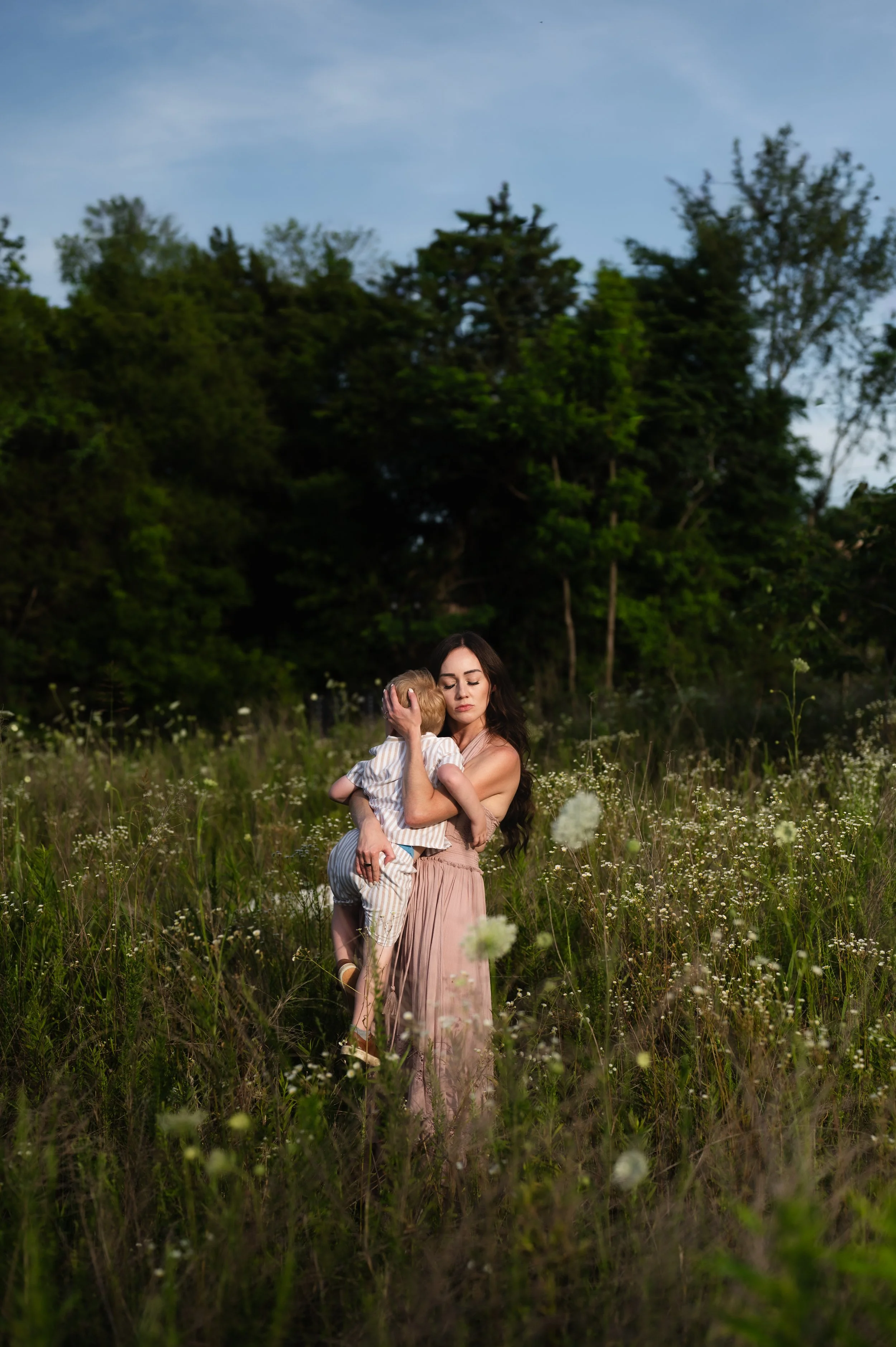 woman with child in flower field at sunset, motherhood, photographer, family photos, clarksville and nashville tennessee, affordable