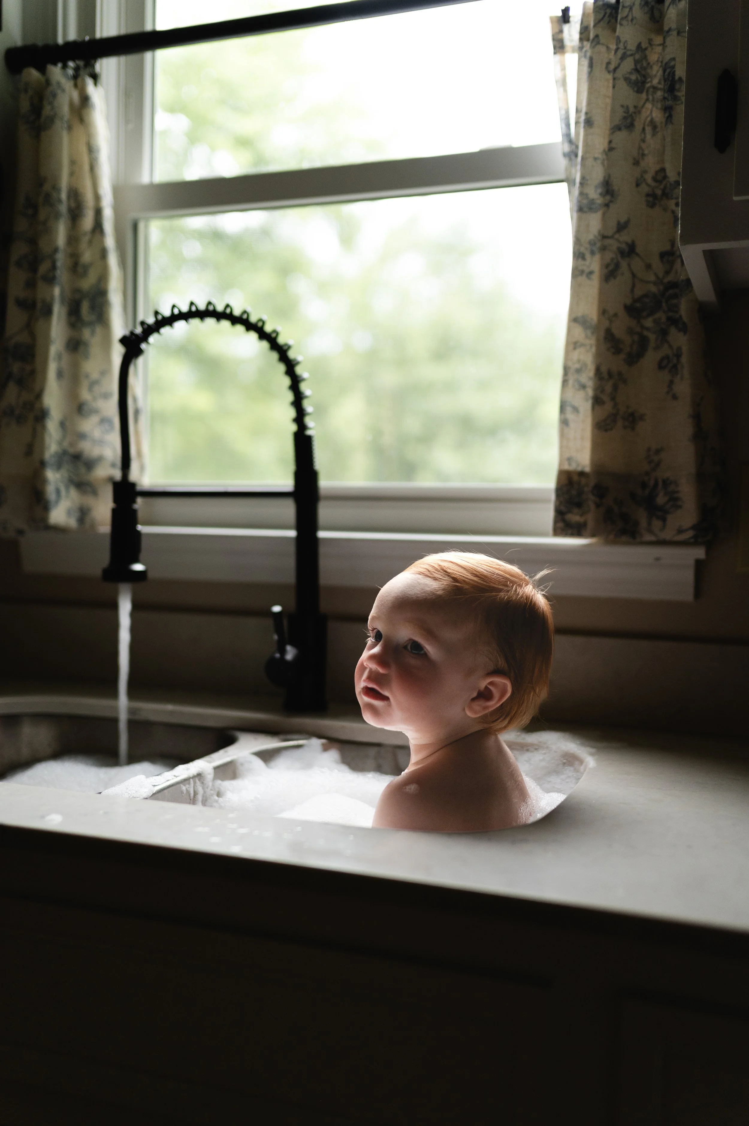 child in kitchen sink with bubbles, clarksville tennessee, affordable, nashville, birthday photos